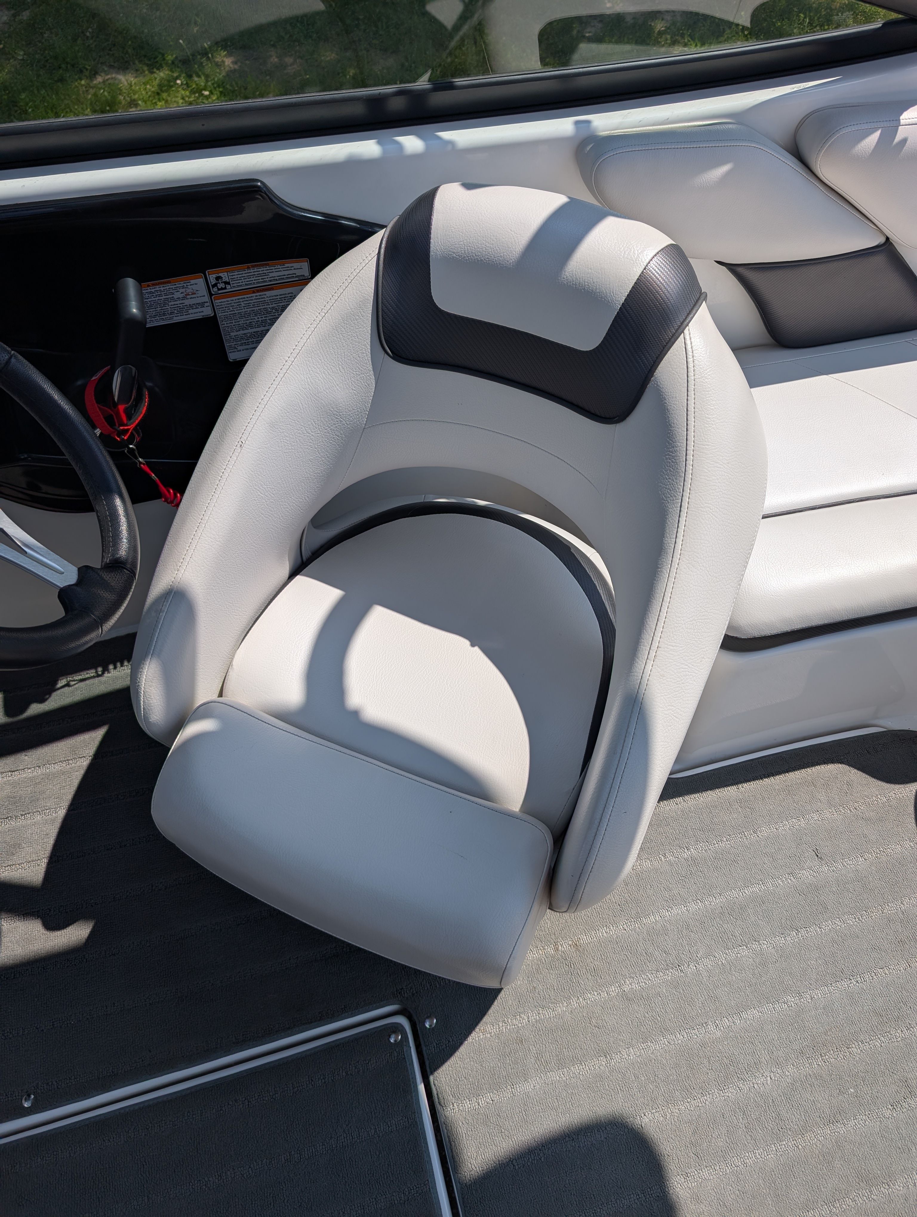 A white cushioned boat seat with black accent in a 2014 Yamaha AR192.