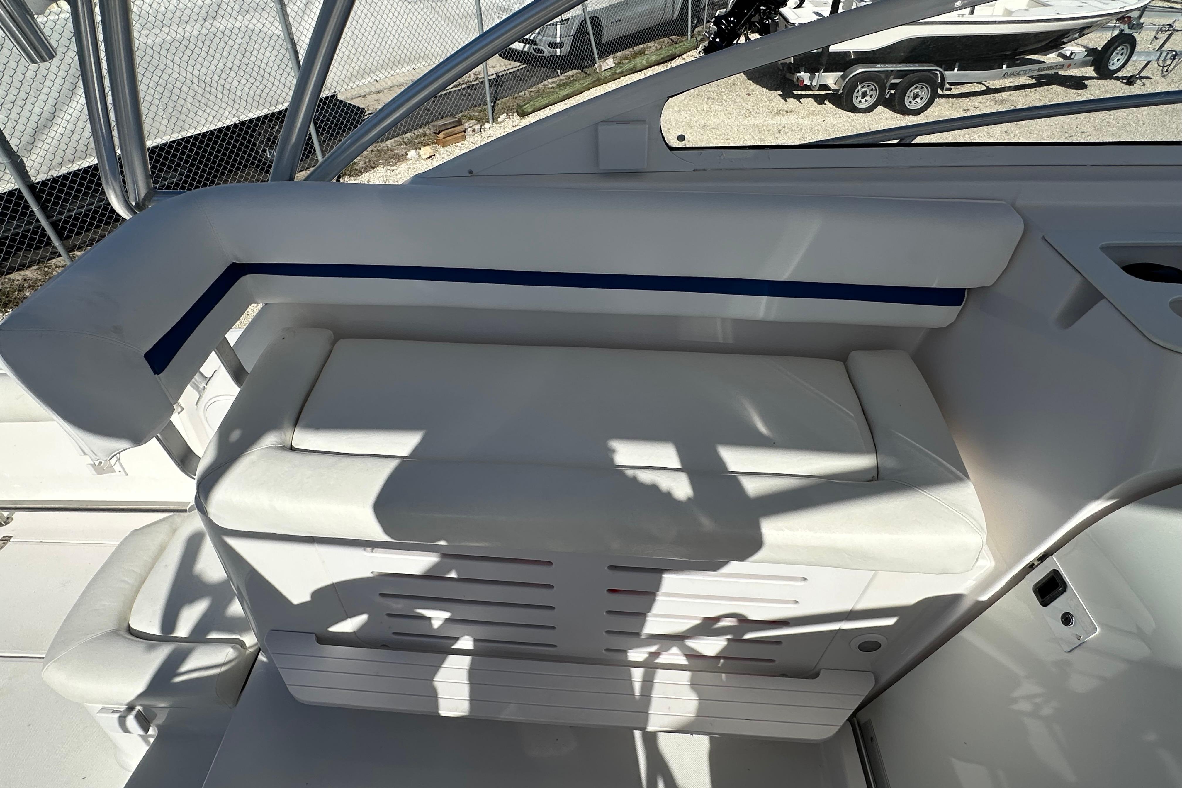 2006 Pro-Line 32 Express boat seating area with white upholstery and blue accent.
