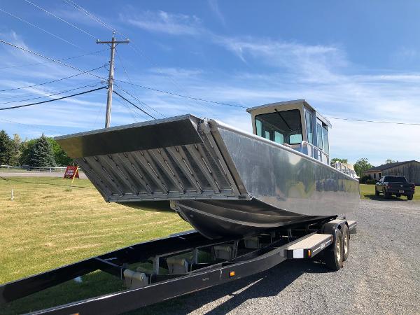 A 2026 Workboat Bayview Boats Landing Craft on a trailer, parked on a gravel path.