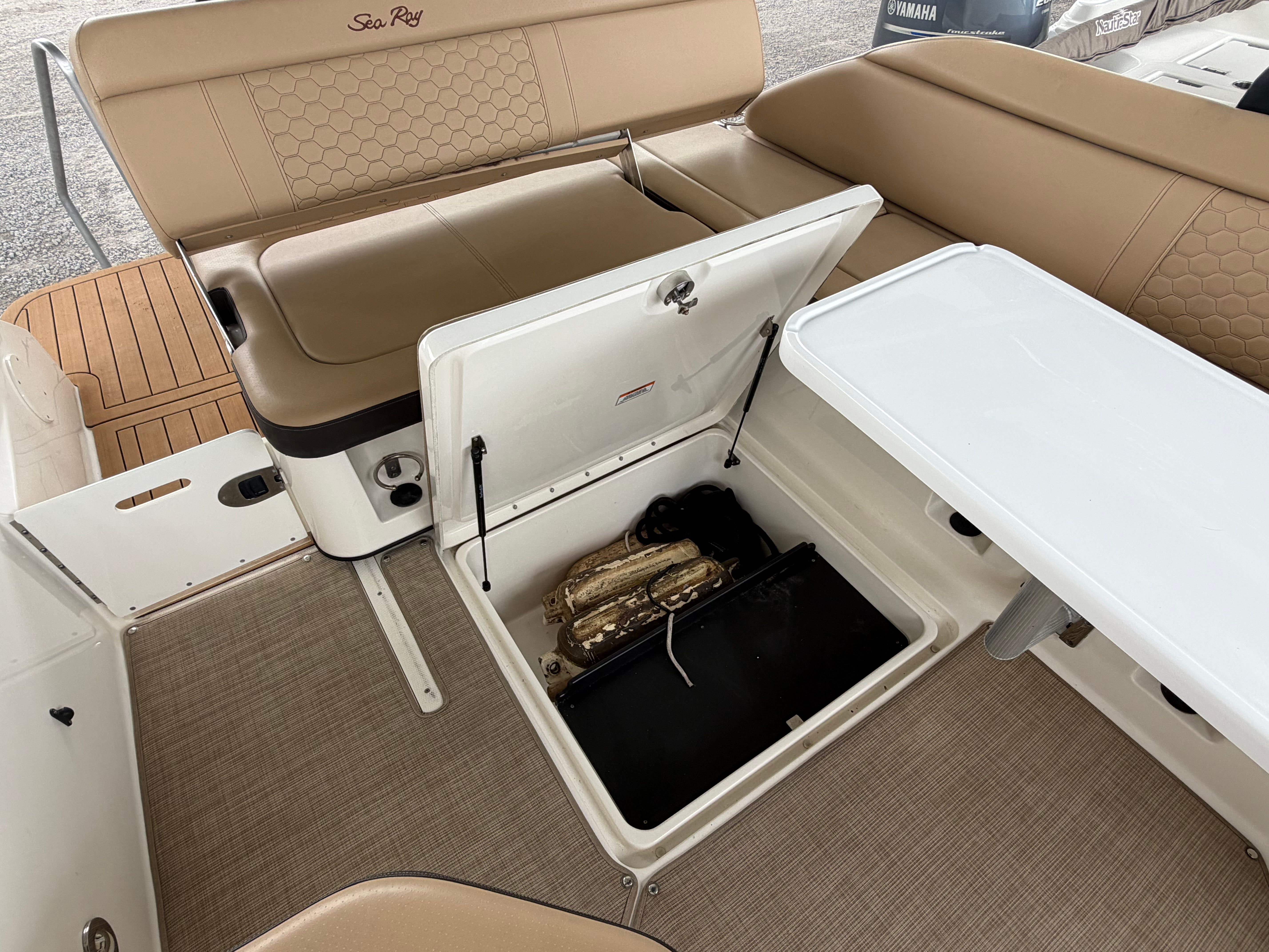 Interior of a Sea Ray SDX 250 Outboard boat, seating area and storage.