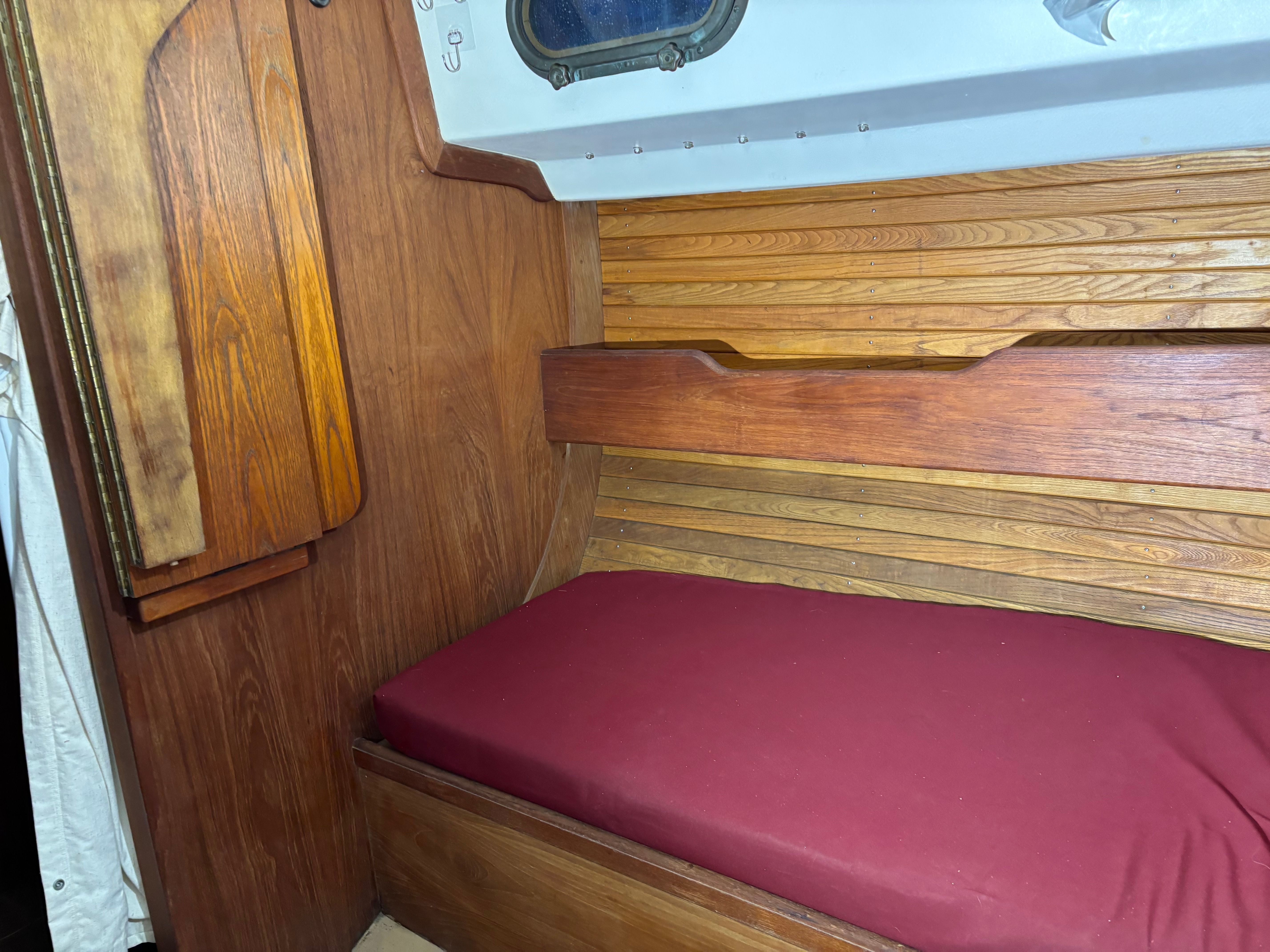 Interior of a 1986 Cape Dory 26 yacht with wooden furnishings.