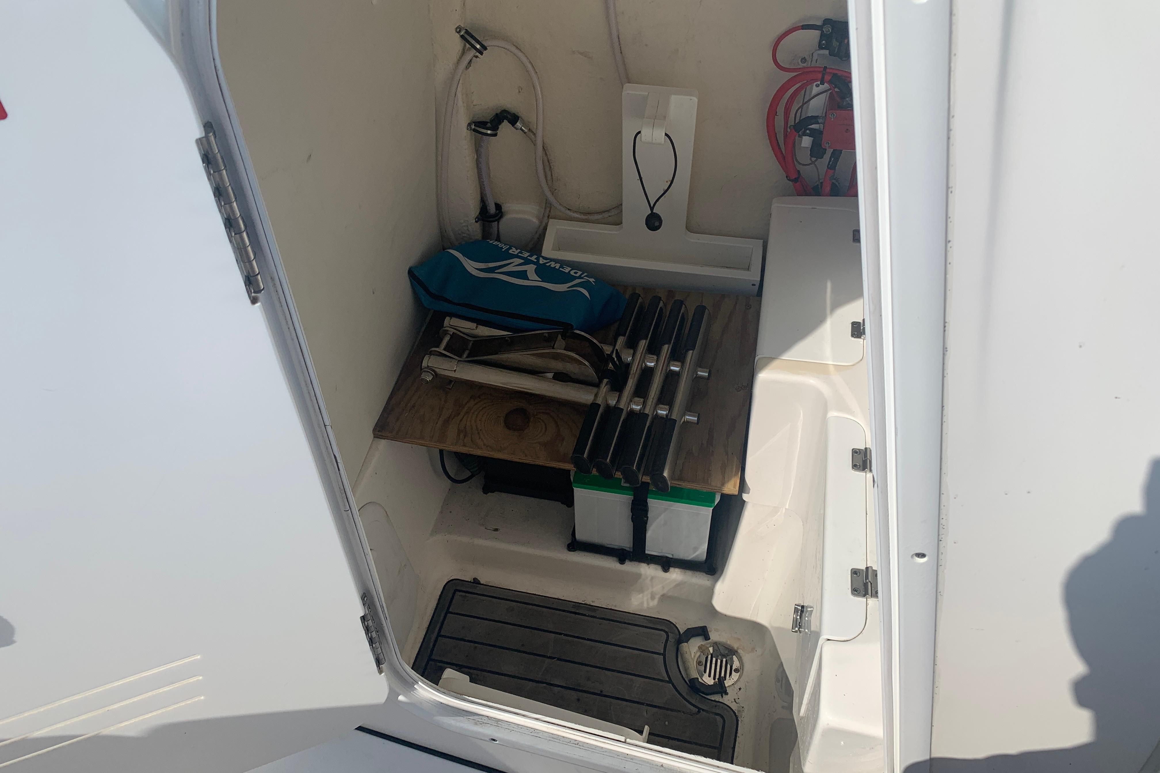 Storage compartment of 2021 Tidewater 256 CC Adventure boat with equipment and accessories.