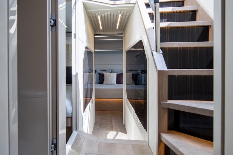 Luxurious interior of 2023 Absolute 62 Fly yacht with modern staircase and elegant design.
