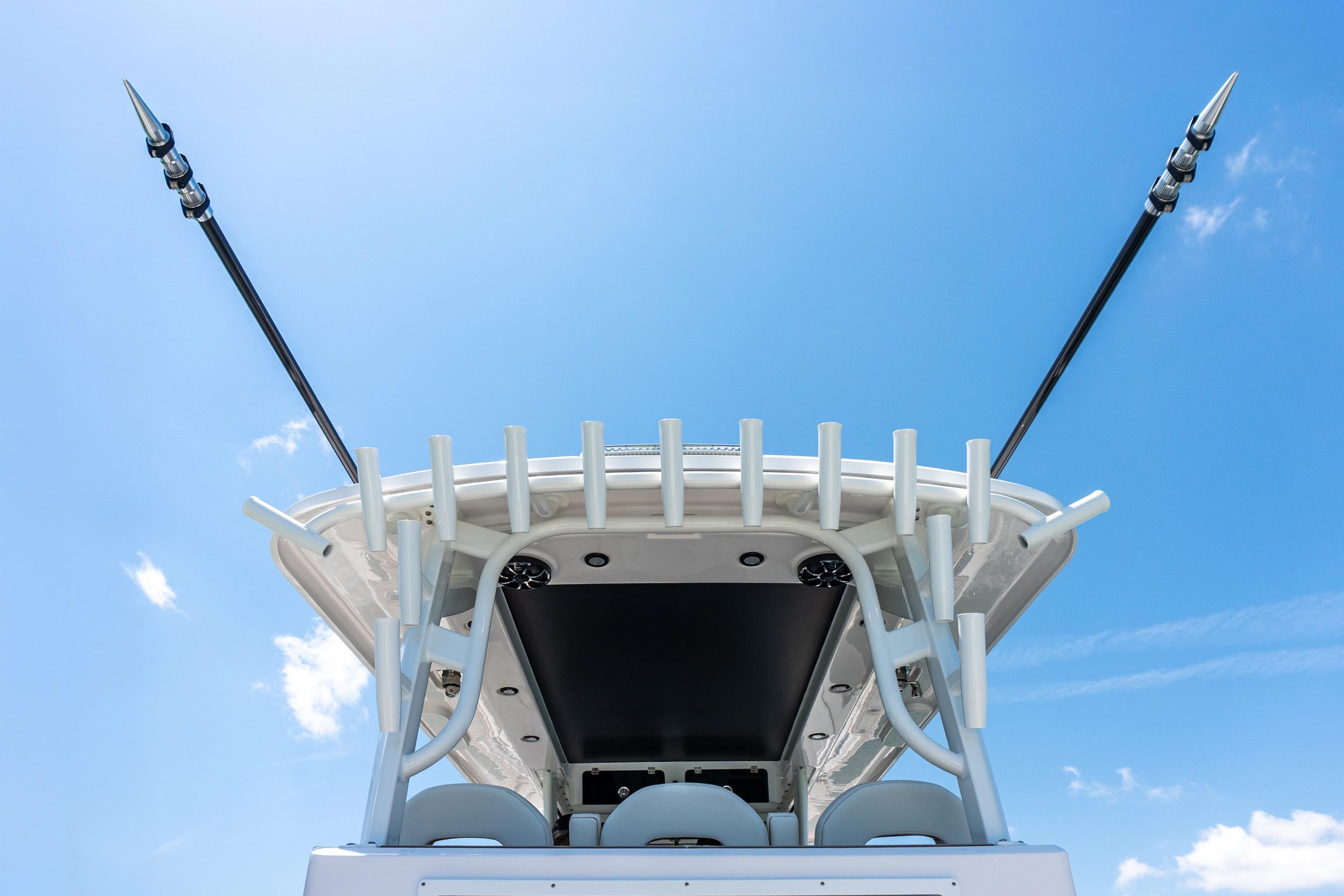 Twin Vee 400 GFX2 CC 2026 boat with fishing rod holders against a clear blue sky.