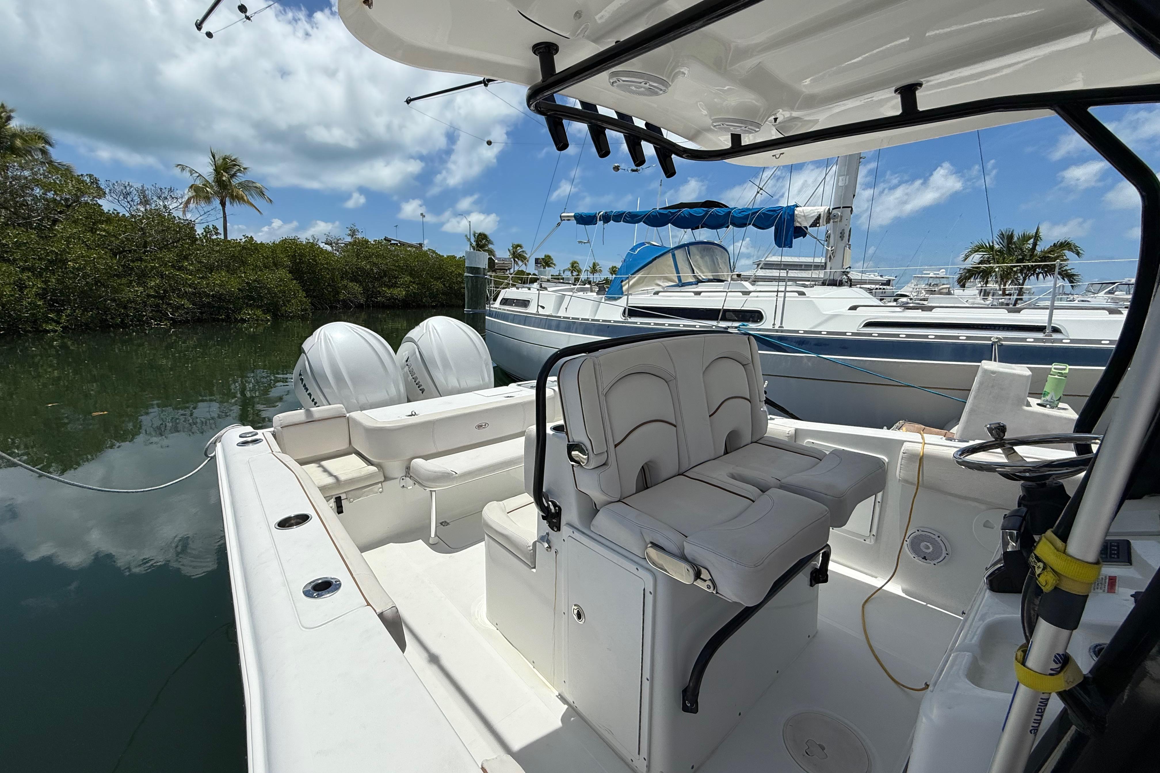 2022 Sea Hunt Gamefish 30 Coffin Box boat docked, featuring dual engines and spacious seating.
