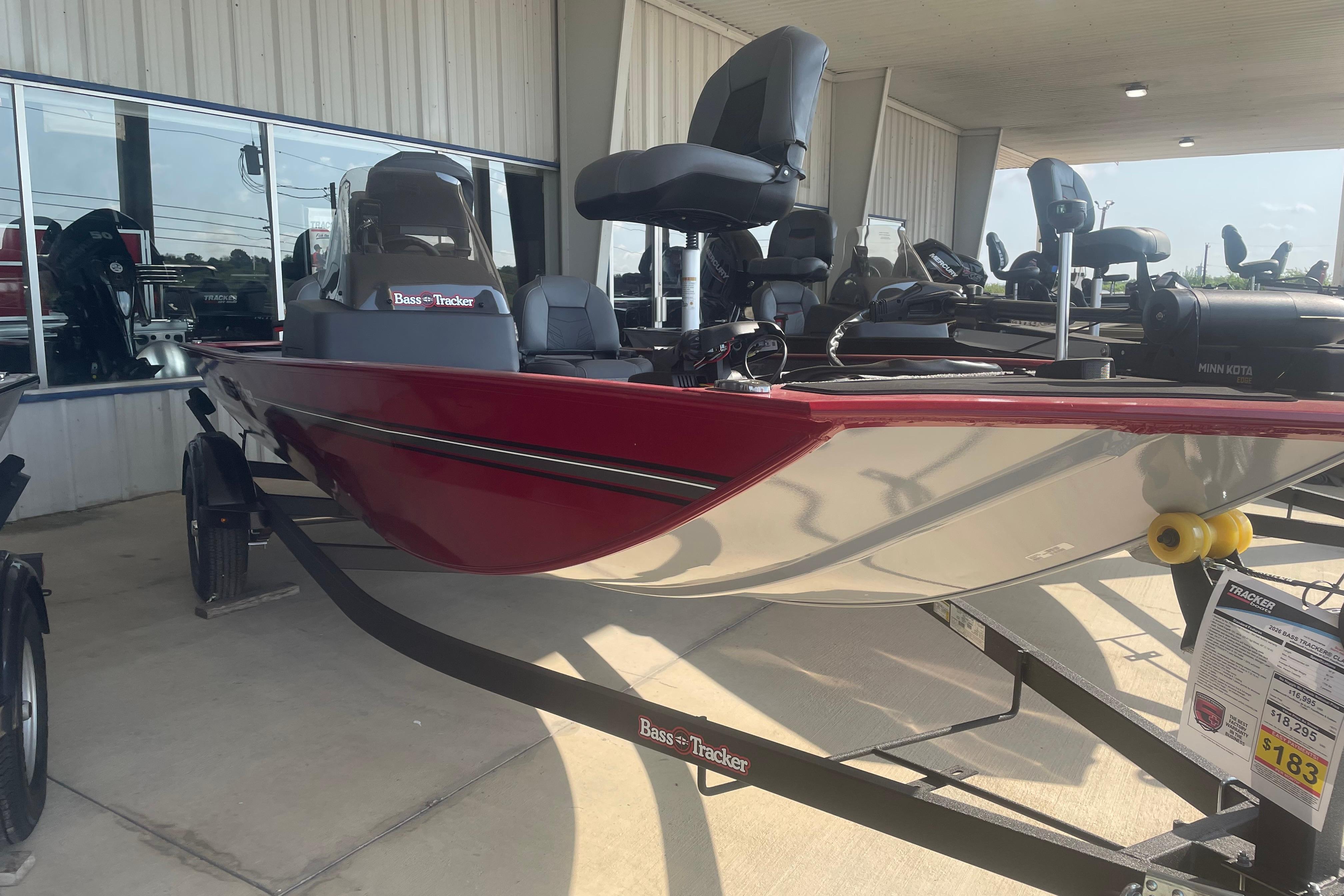 2026 Tracker Bass Tracker Classic XL boat displayed in showroom, featuring sleek design and modern seating.