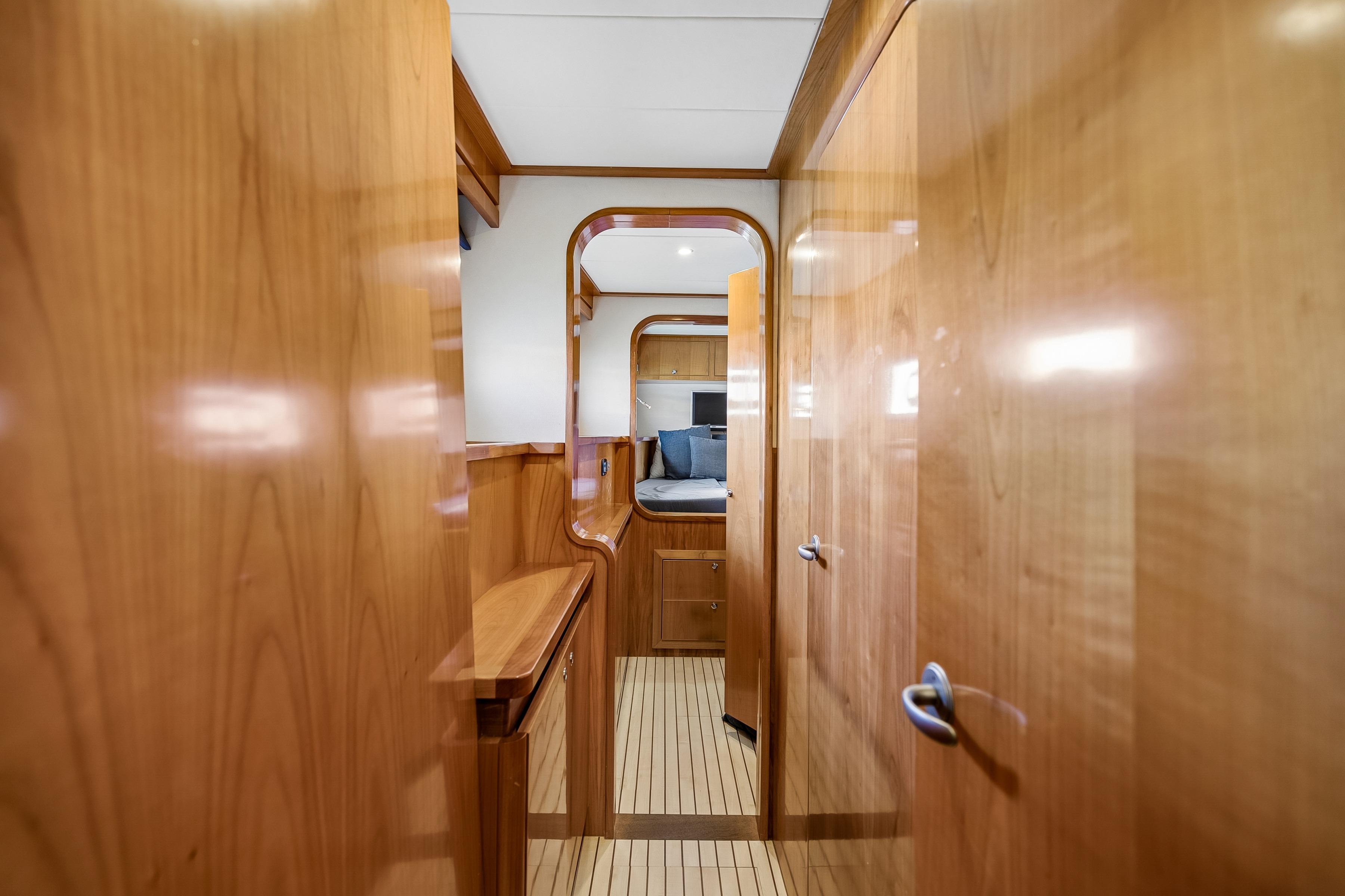 Interior of 2009 Catana 65 yacht with wooden finish and cozy cabin view.