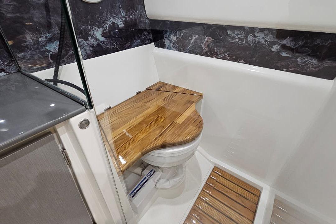 Modern bathroom in 2026 Hanover 327 with wooden toilet cover and sleek design.