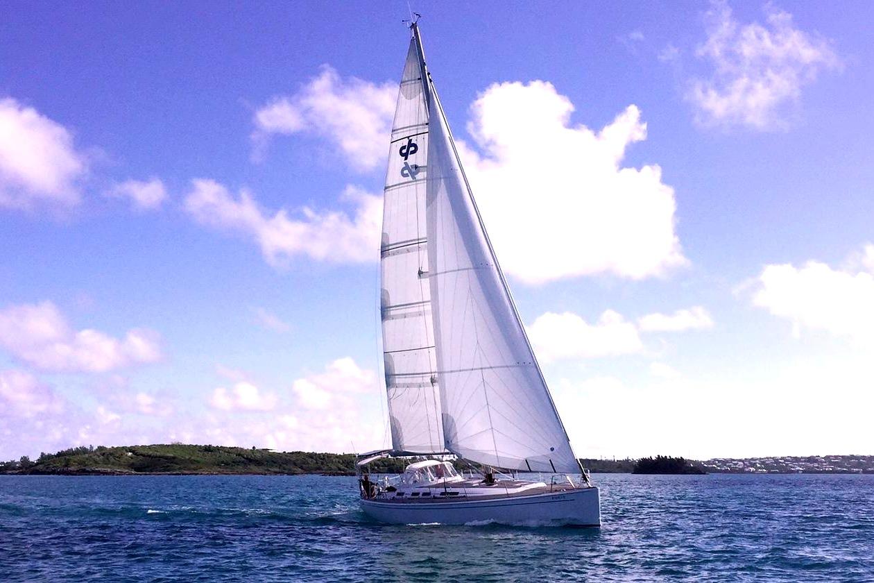 Sailing yacht Grand Soleil 50, 2006 model, gliding on blue waters under a clear sky.