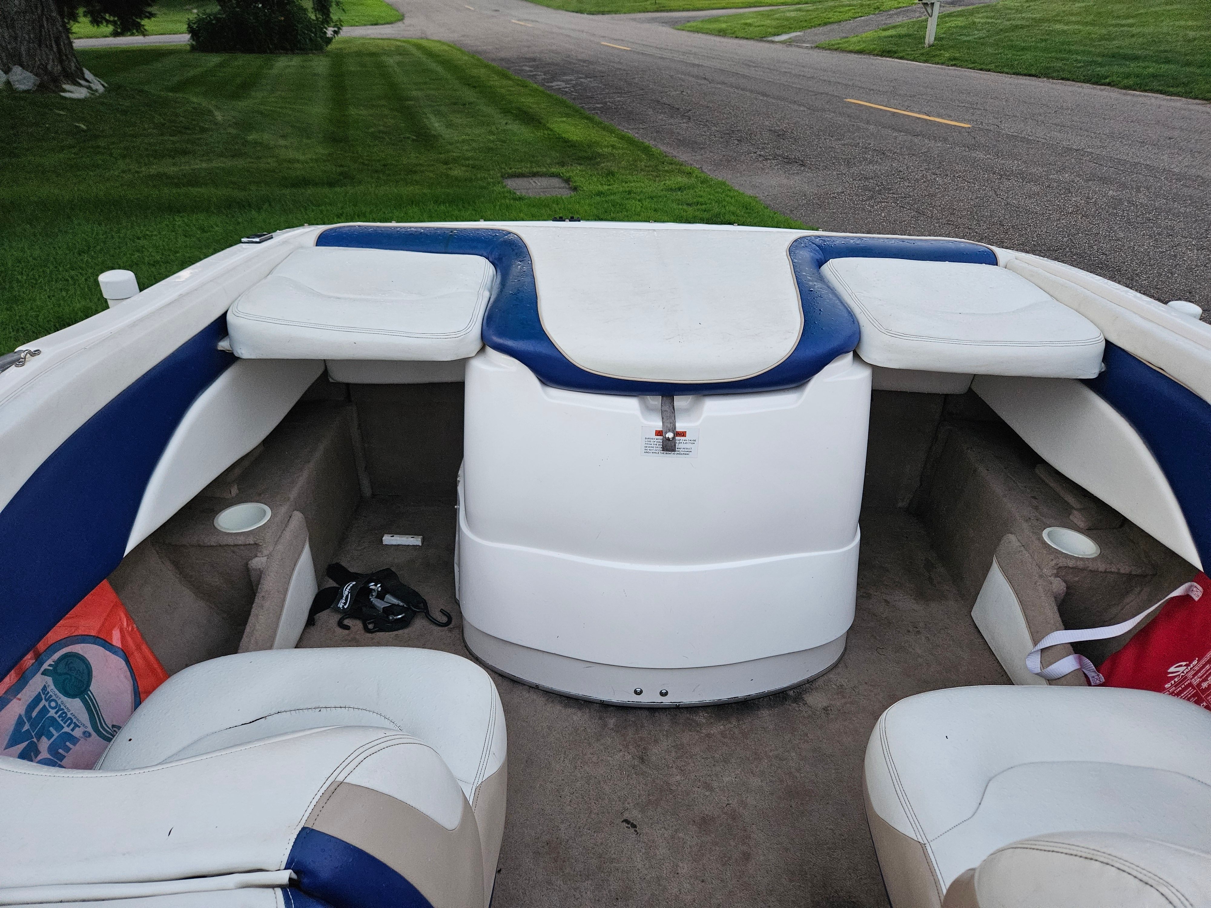 The image shows the cockpit of a 1996 Wellcraft Excel boat with white and blue seating.
