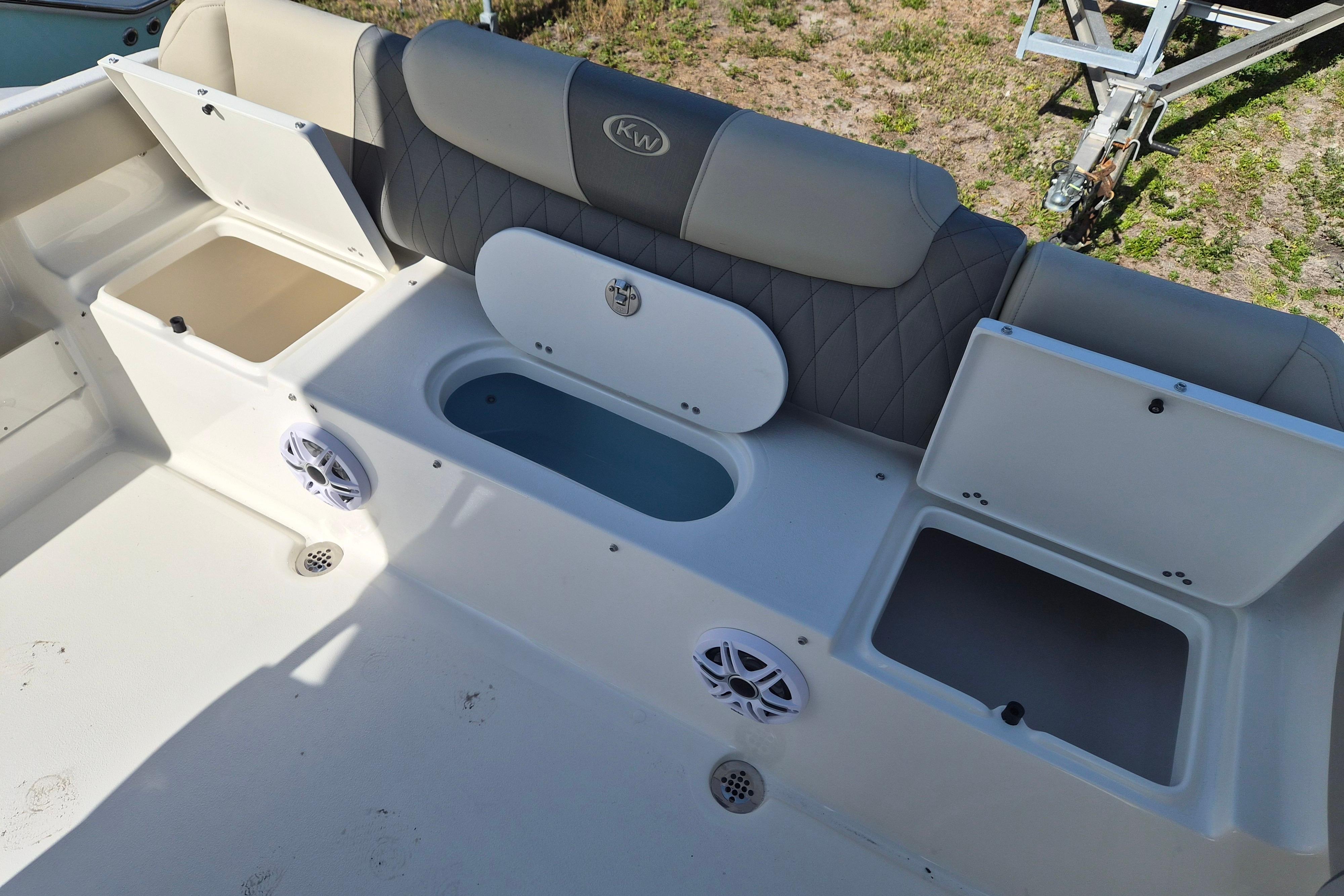 2026 Key West 239 FS boat interior with storage compartments and seating.