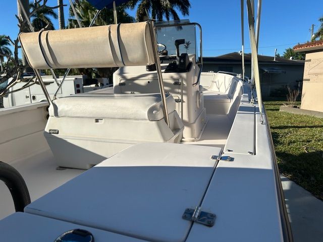 1994 Aquasport Osprey boat with bench seating and helm.