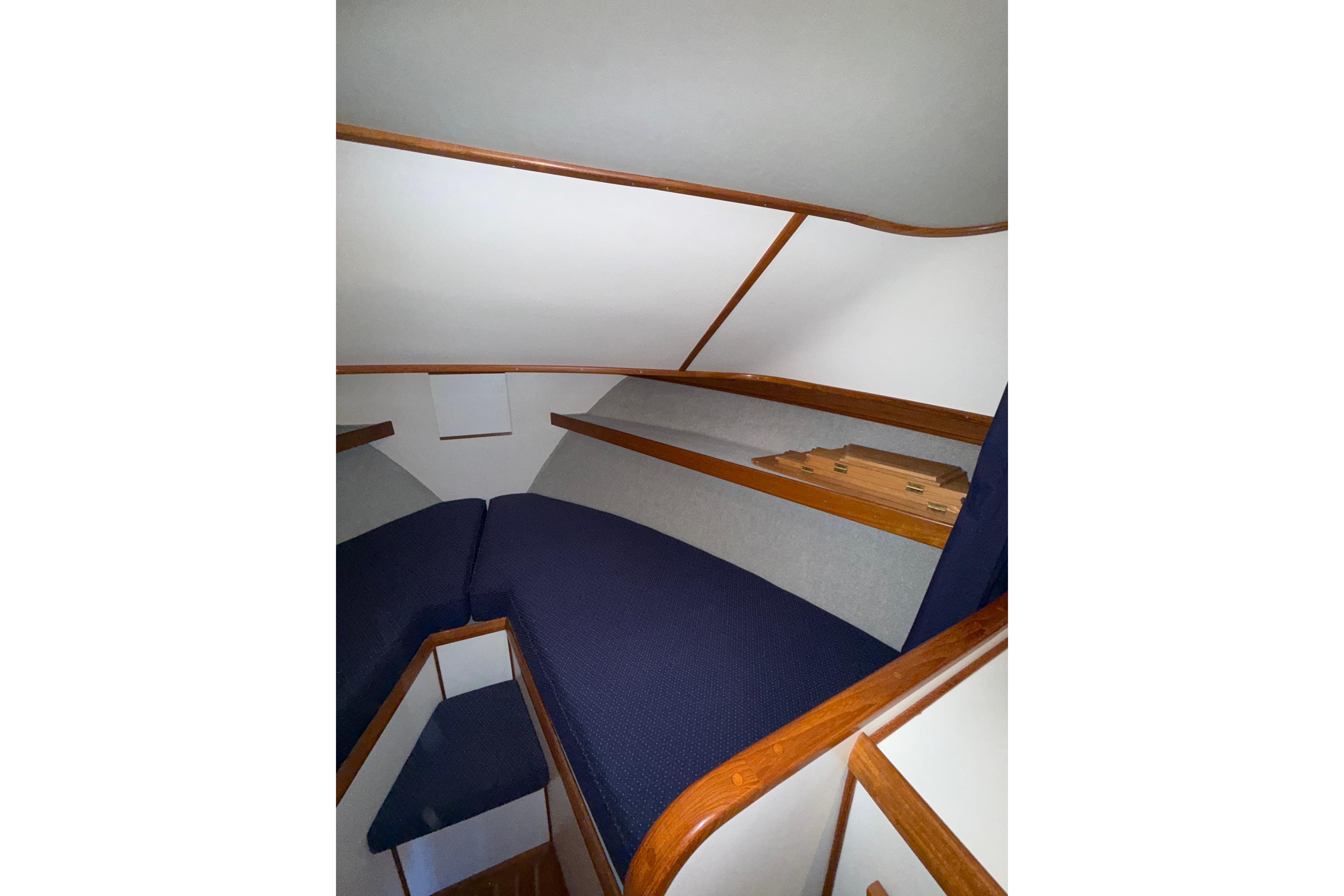 Interior cabin of 1997 Norstar 301 boat with blue cushions and wooden trim.