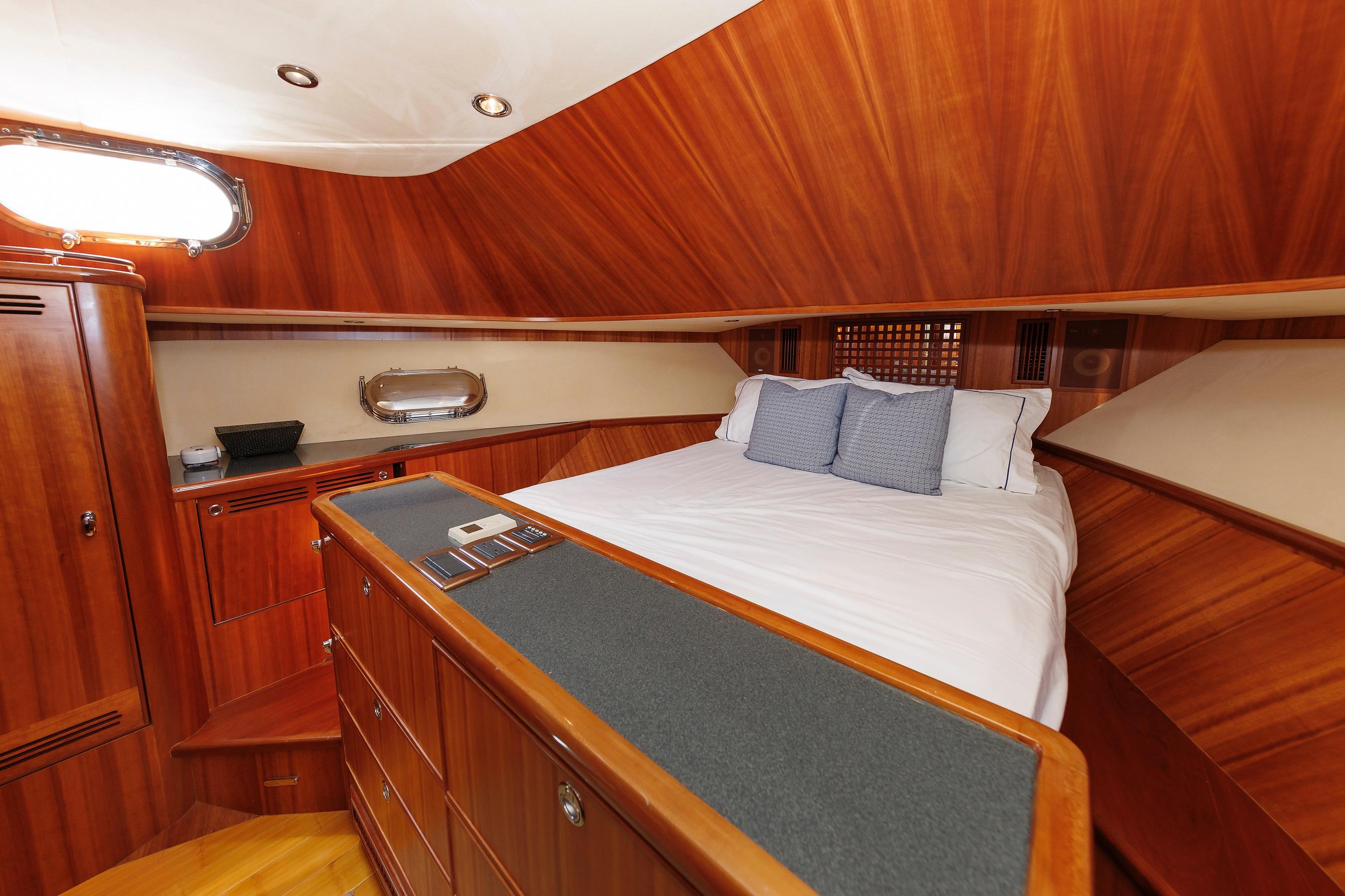 Luxurious 2009 Hunt Yachts 52 Express cabin with elegant wood finish and cozy bedding.