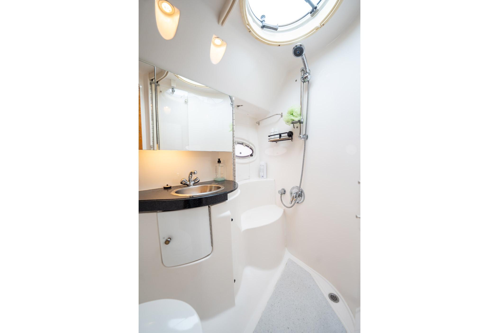 Luxurious bathroom in 2008 Regal Commodore 4460 yacht with modern fixtures and shower.