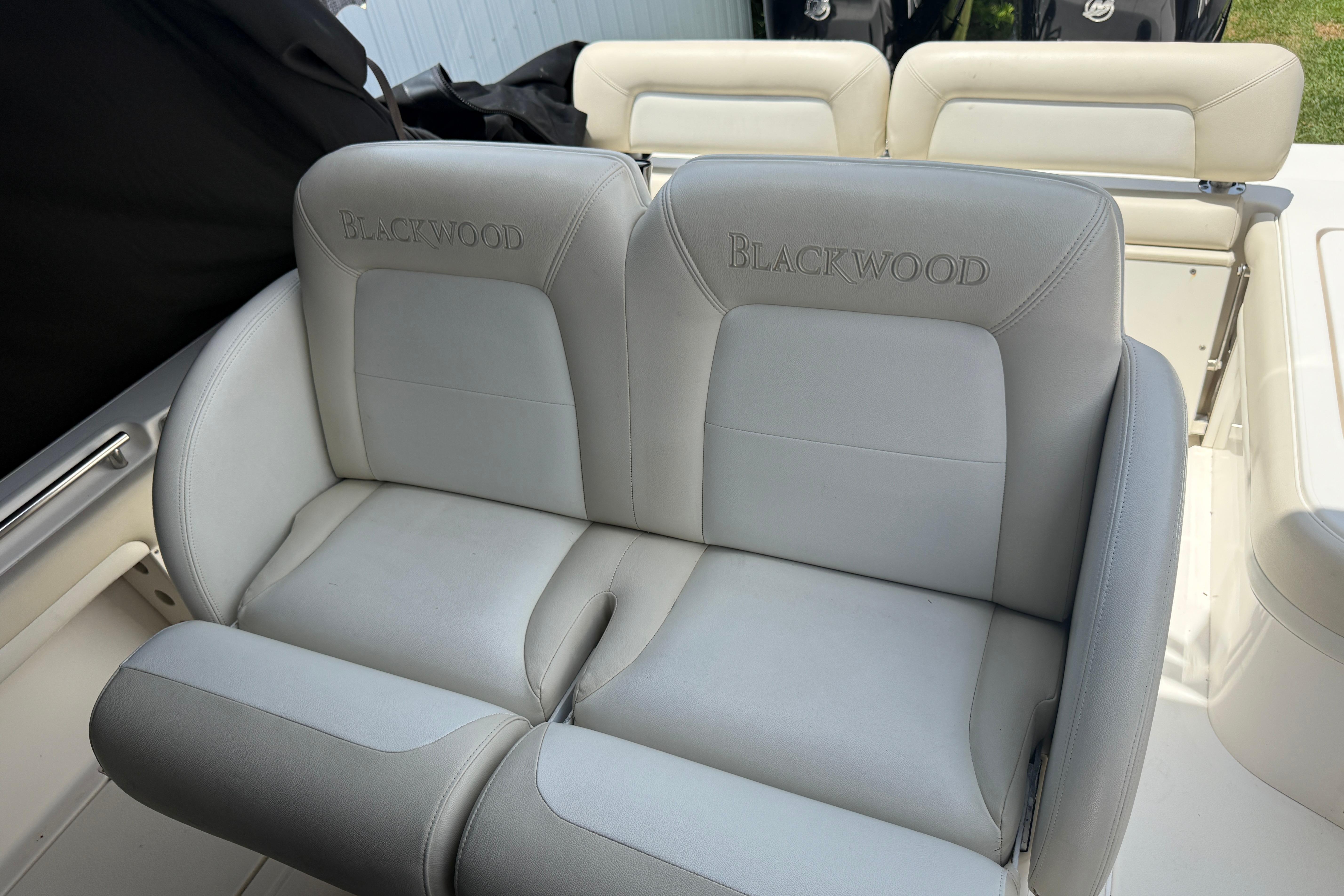 Luxury seating on a 2015 Blackwood 27 boat, featuring embroidered branding.