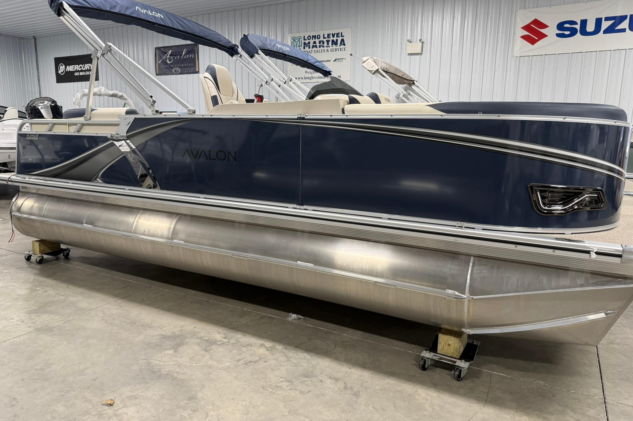 2026 Avalon LSZ Elite 21' pontoon boat in showroom, featuring sleek design and modern amenities.