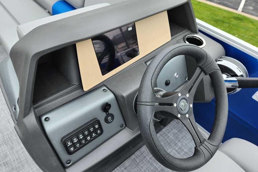 Steering console of 2026 Sun Tracker Party Barge 20 DLX with modern controls and display.