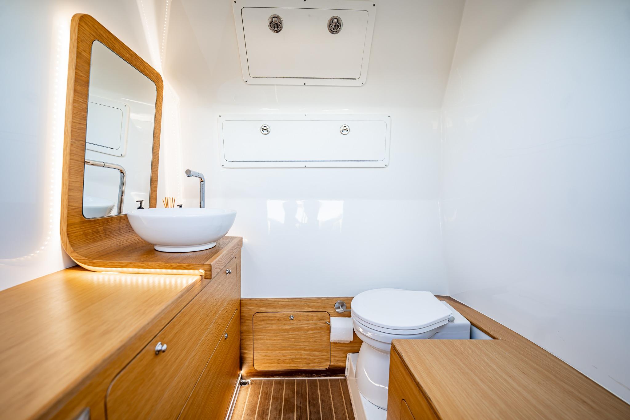 Modern bathroom interior in 2023 Skipper-BSK 38NC boat, featuring wood accents and sleek fixtures.