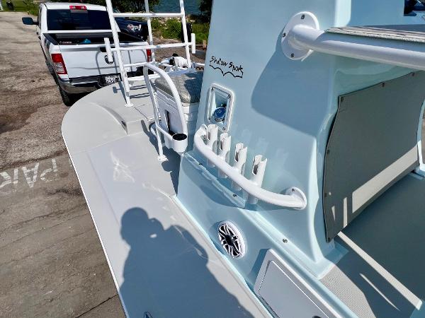 2022 Shallow Sport 20 Classic boat with rod holders and a white pickup truck in the background.