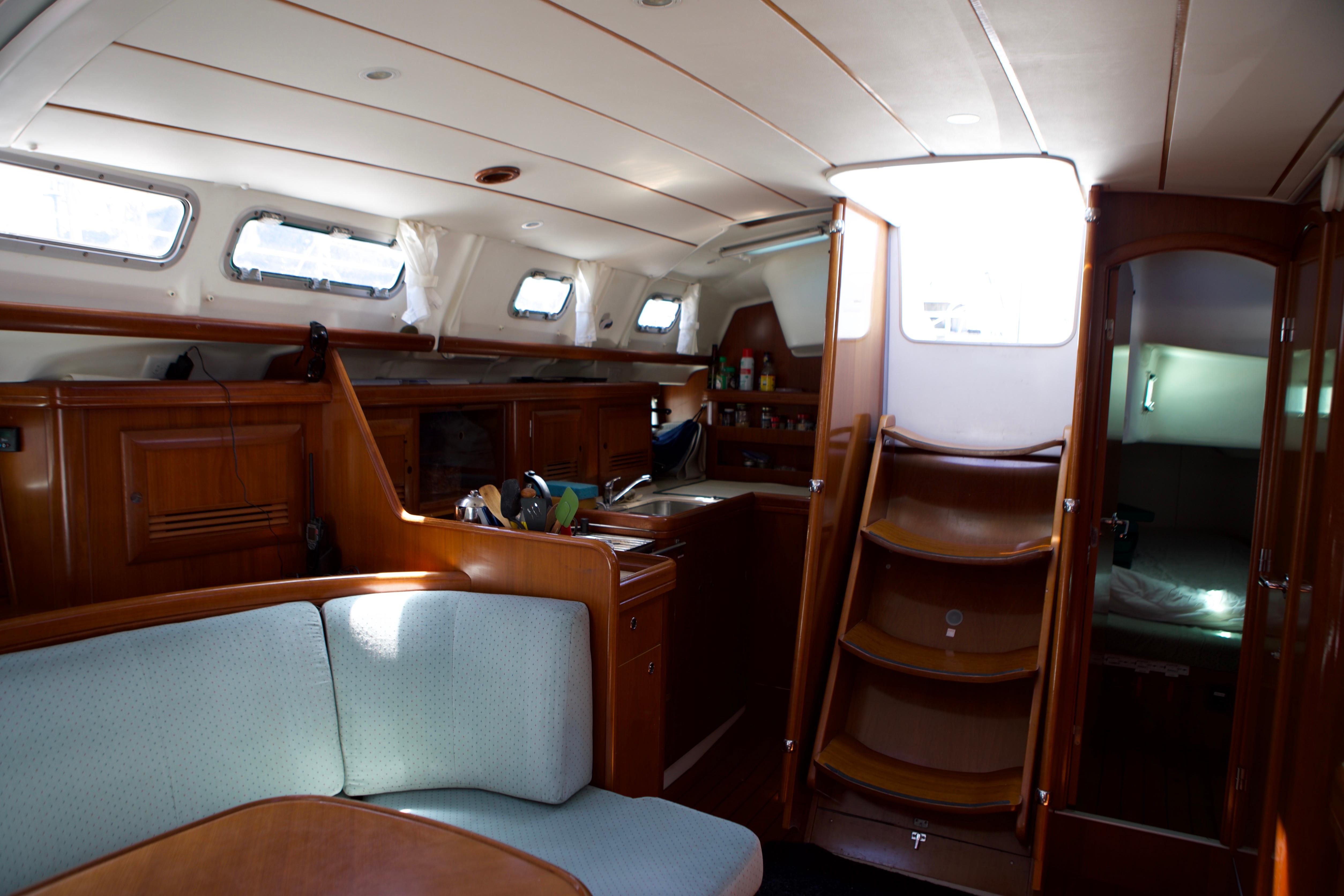 Interior of a 2005 Beneteau 423 sailboat, featuring a cozy cabin with wooden finishes.