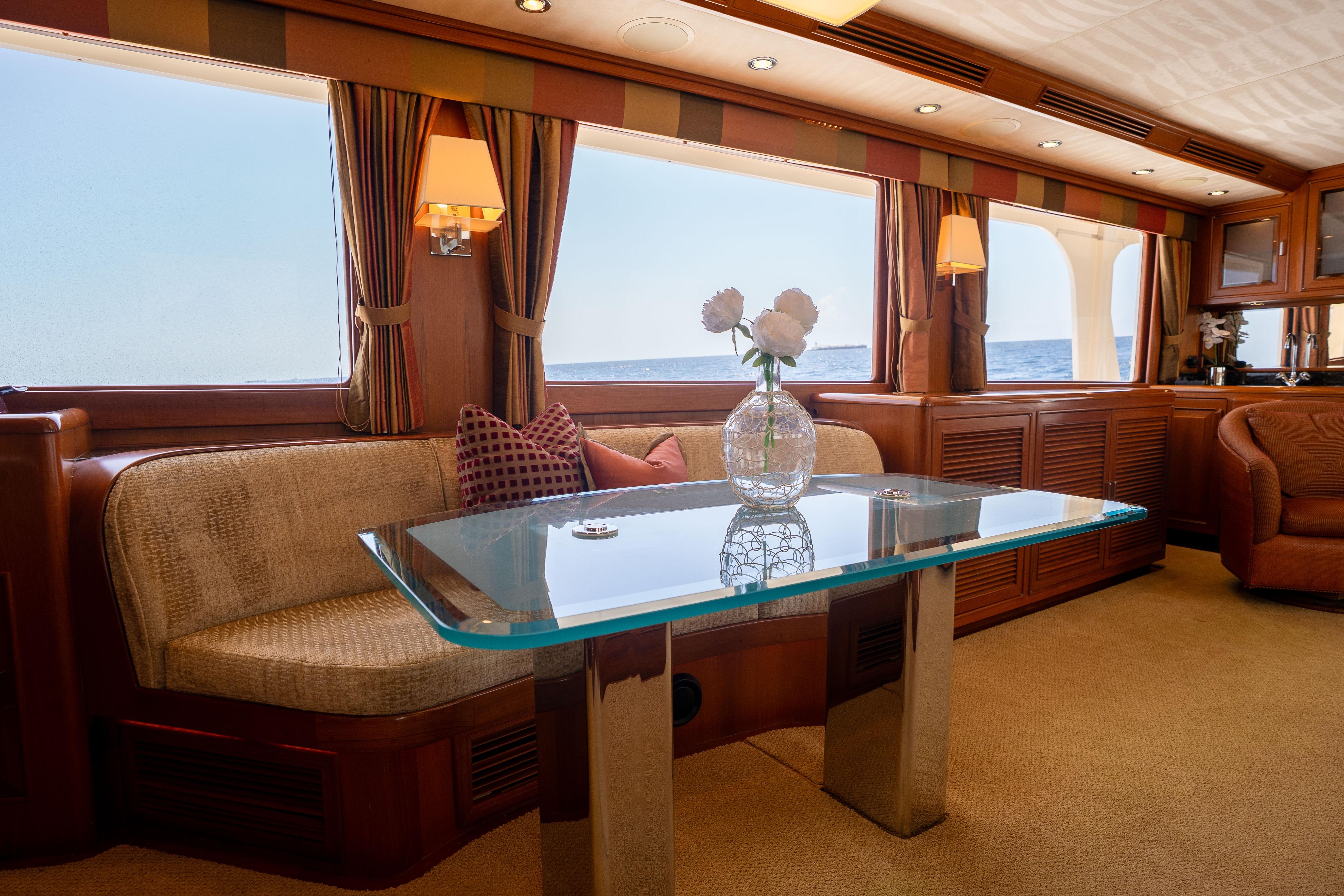 Luxurious interior of 2006 Fleming 75 yacht with elegant seating and ocean view.