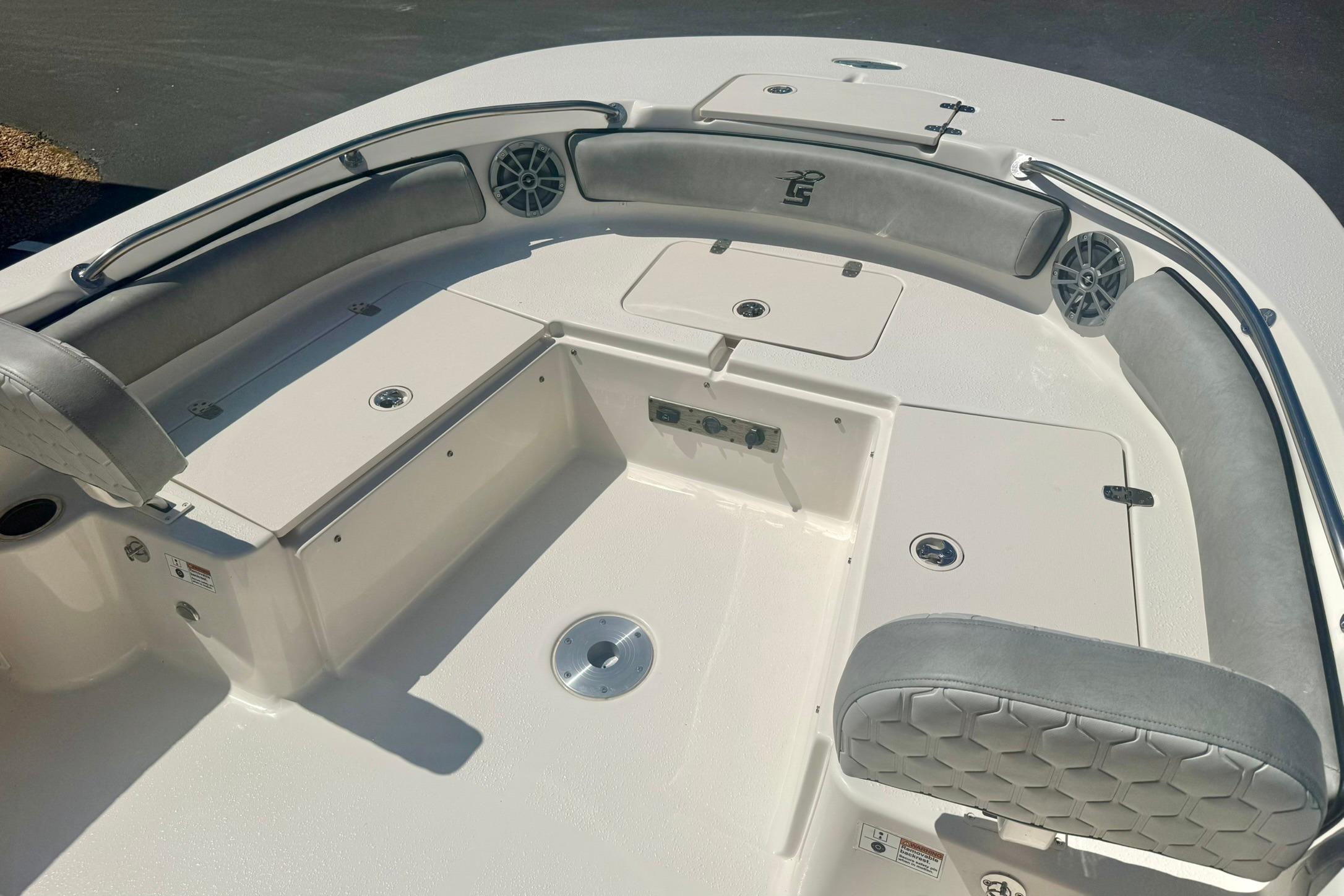 2026 Carolina Skiff 21 Ultra Elite boat interior with cushioned seating and storage compartments.