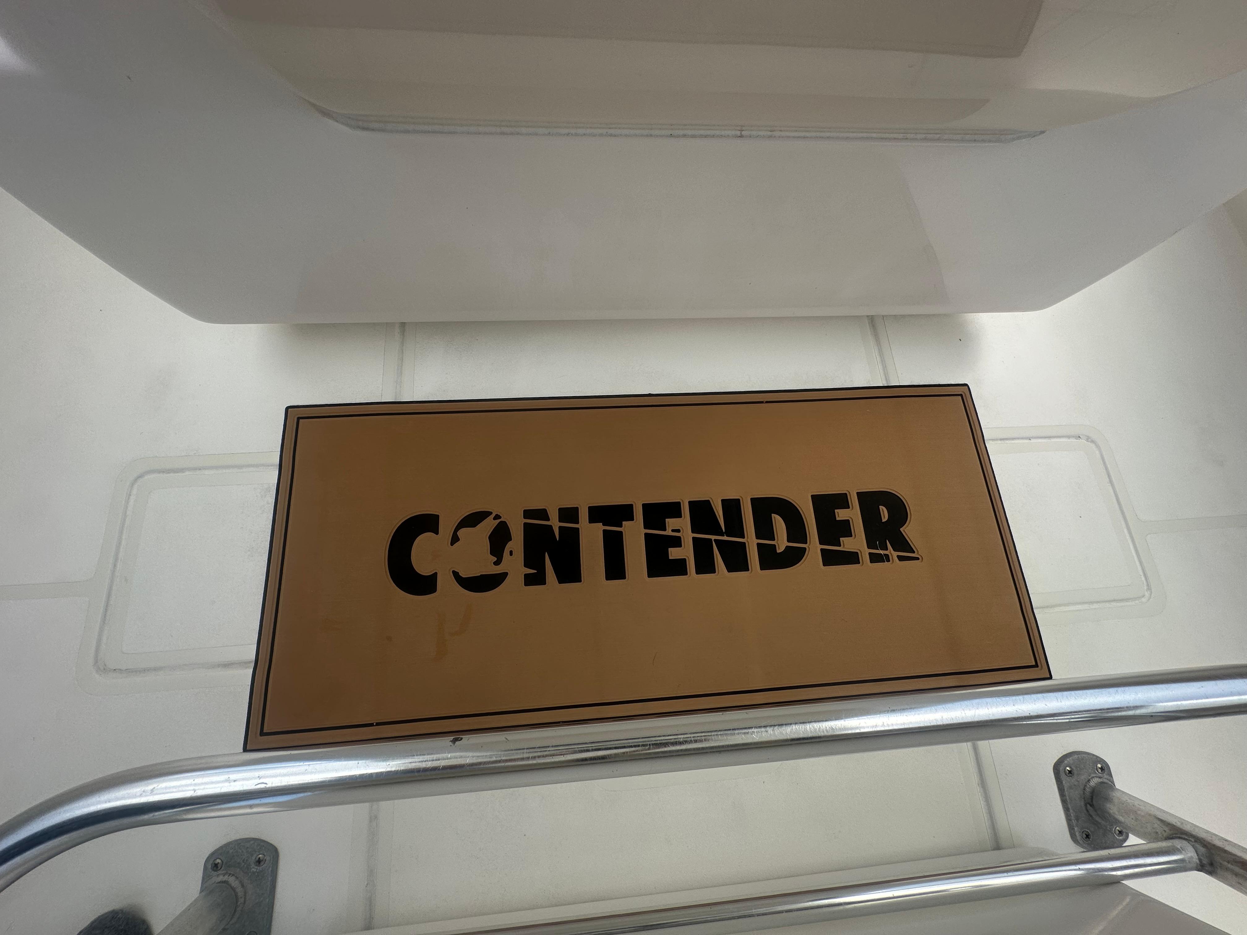 Contender 36 Open 2008 boat deck with branded mat and railing.