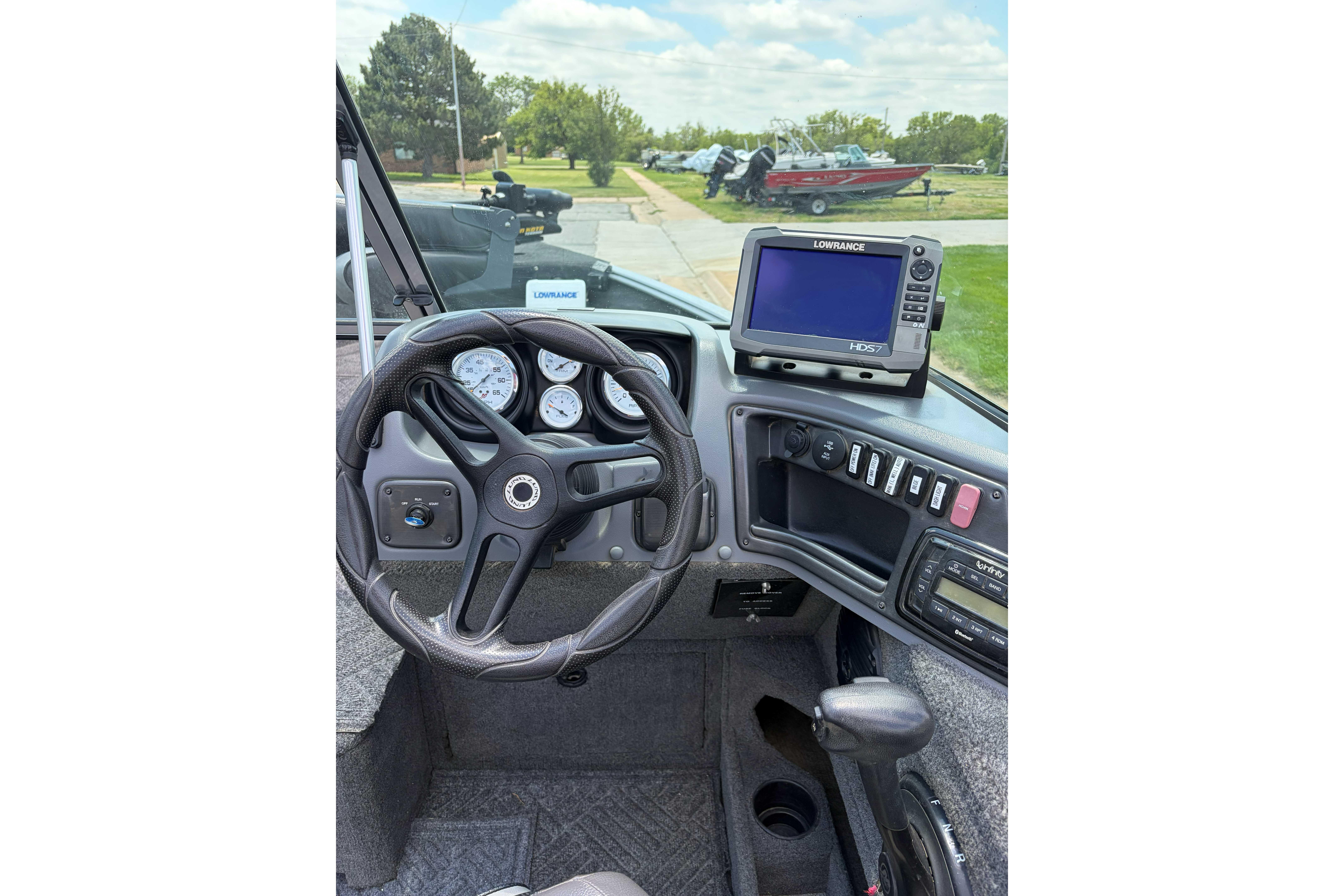 2014 Lund 1875 Impact XS boat dashboard with steering wheel and Lowrance HD5 display.