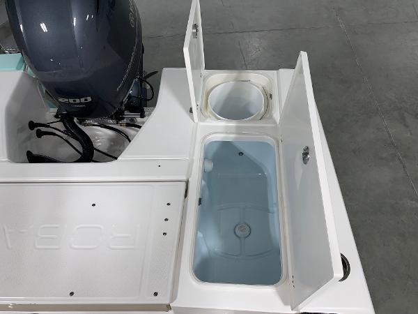 2026 Robalo 226 Cayman boat with open storage compartments and outboard motor.