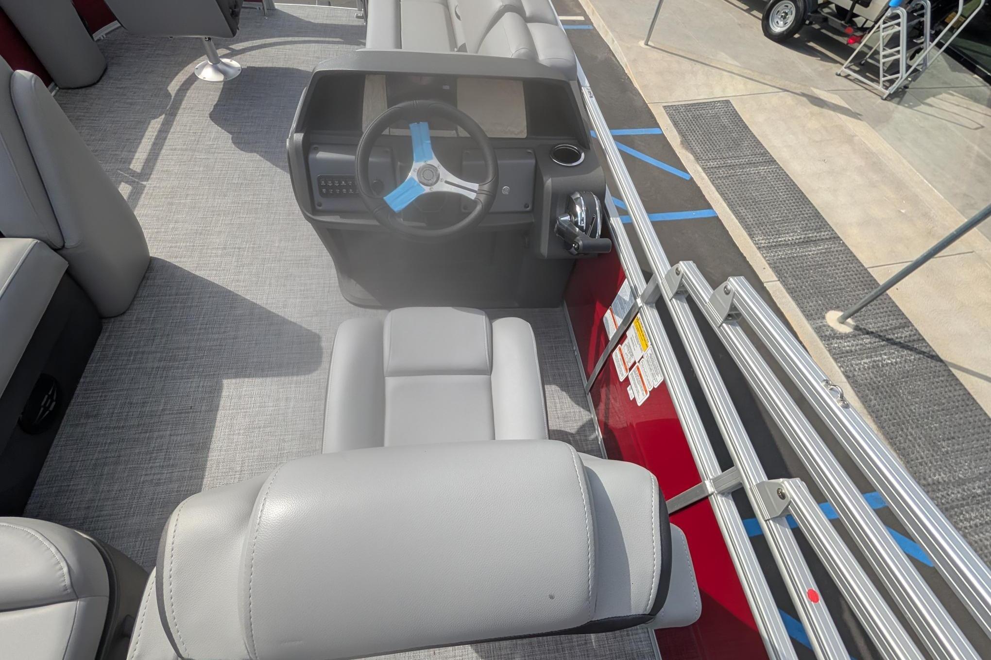2026 Sun Tracker SportFish 20 DLX boat interior with steering console and seating.