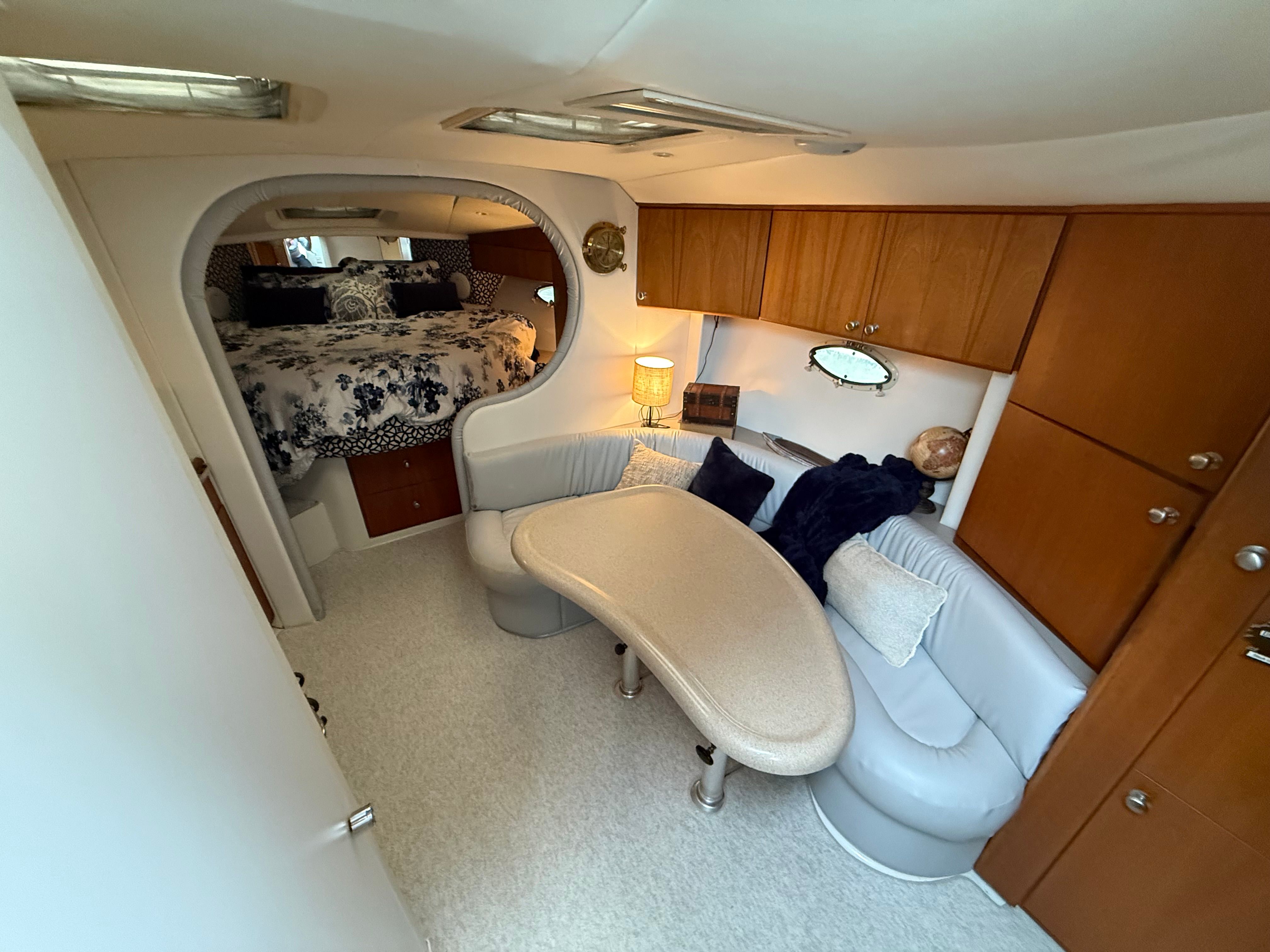 Interior of a 1995 Silverton 360 with a cozy seating area and sleeping quarters.