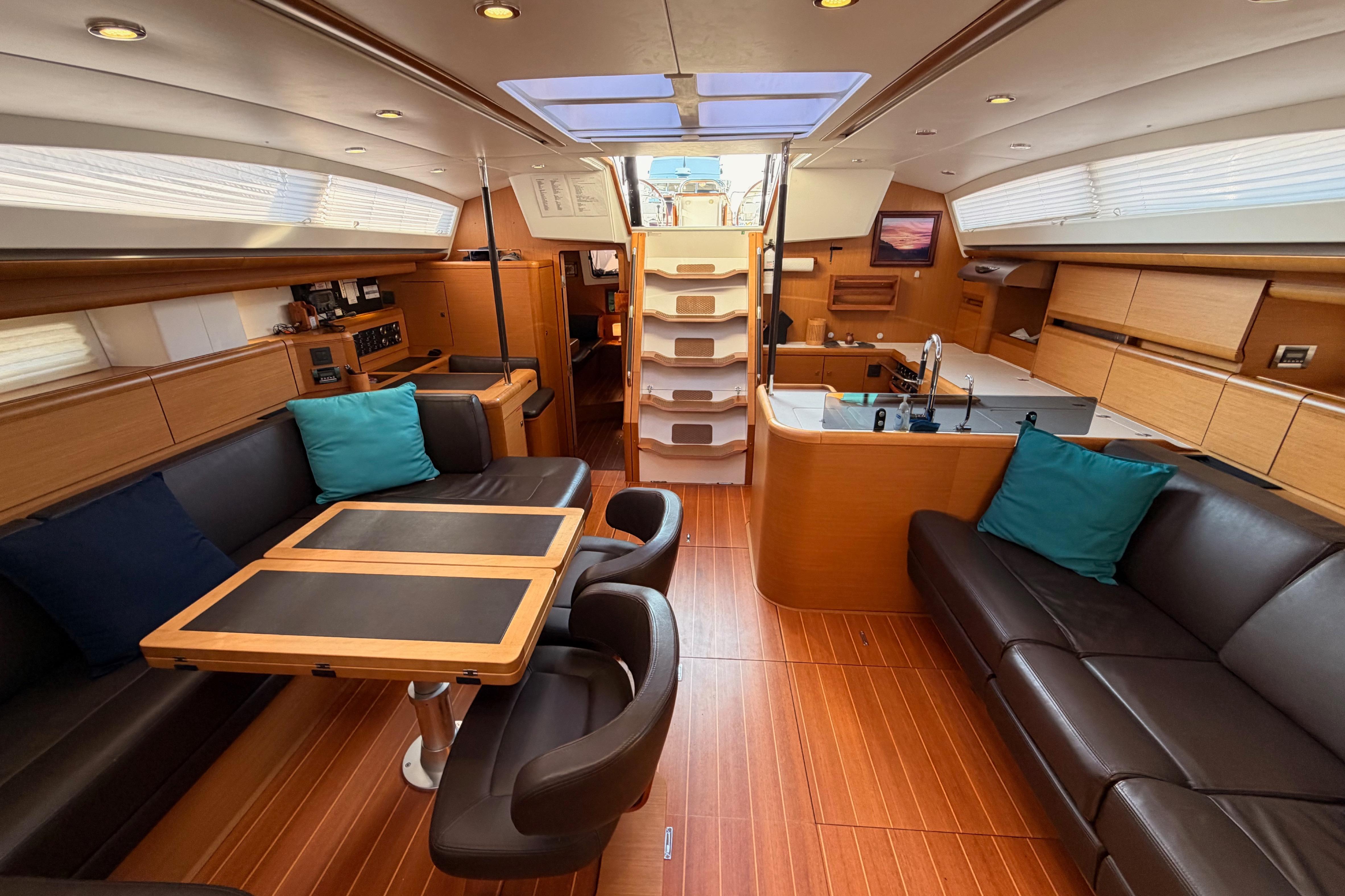 Luxurious interior of a 2013 Jeanneau 57 yacht with elegant wood finishes and modern amenities.
