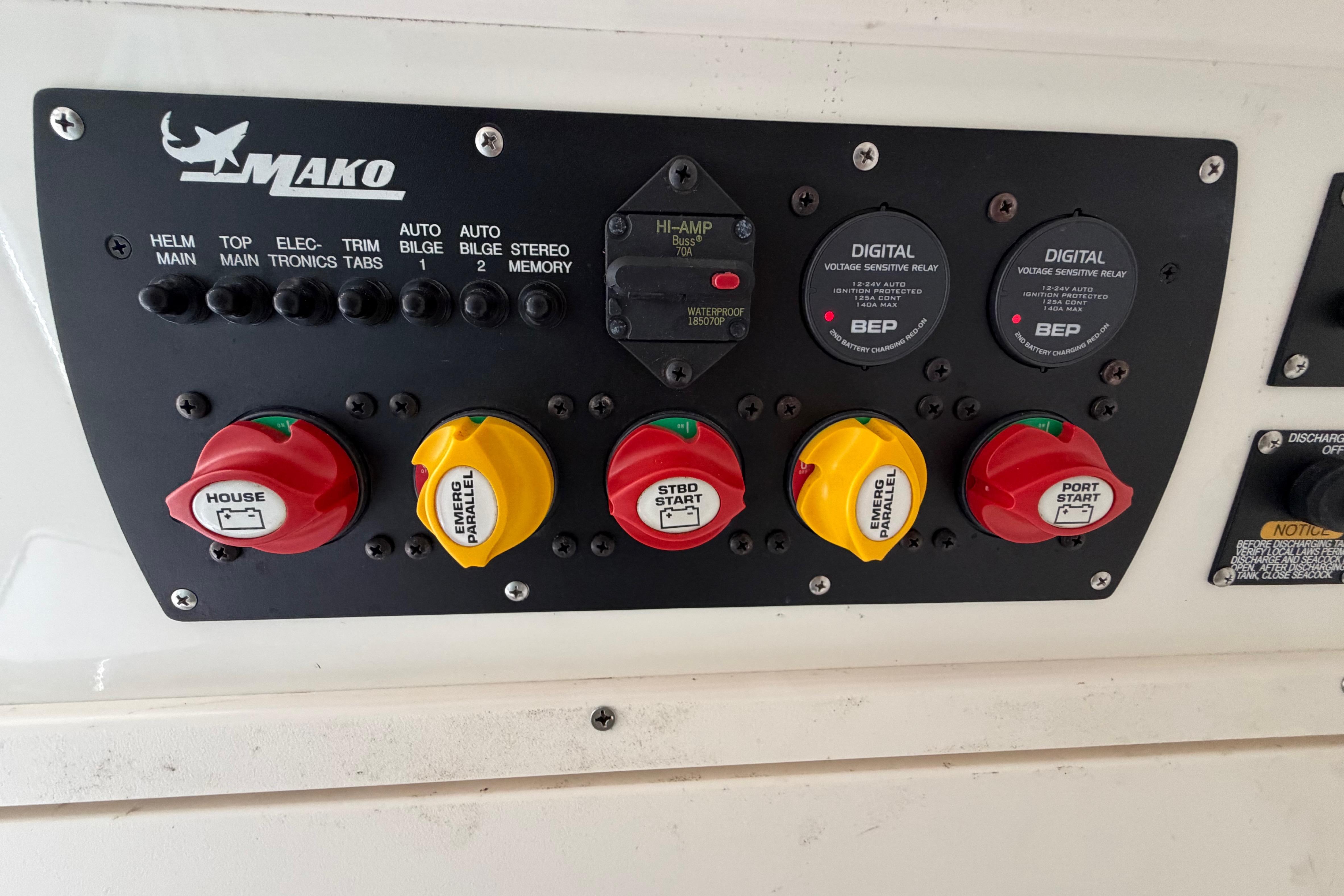 Control panel of a 2017 Mako 284 Center Console boat with switches and relays.