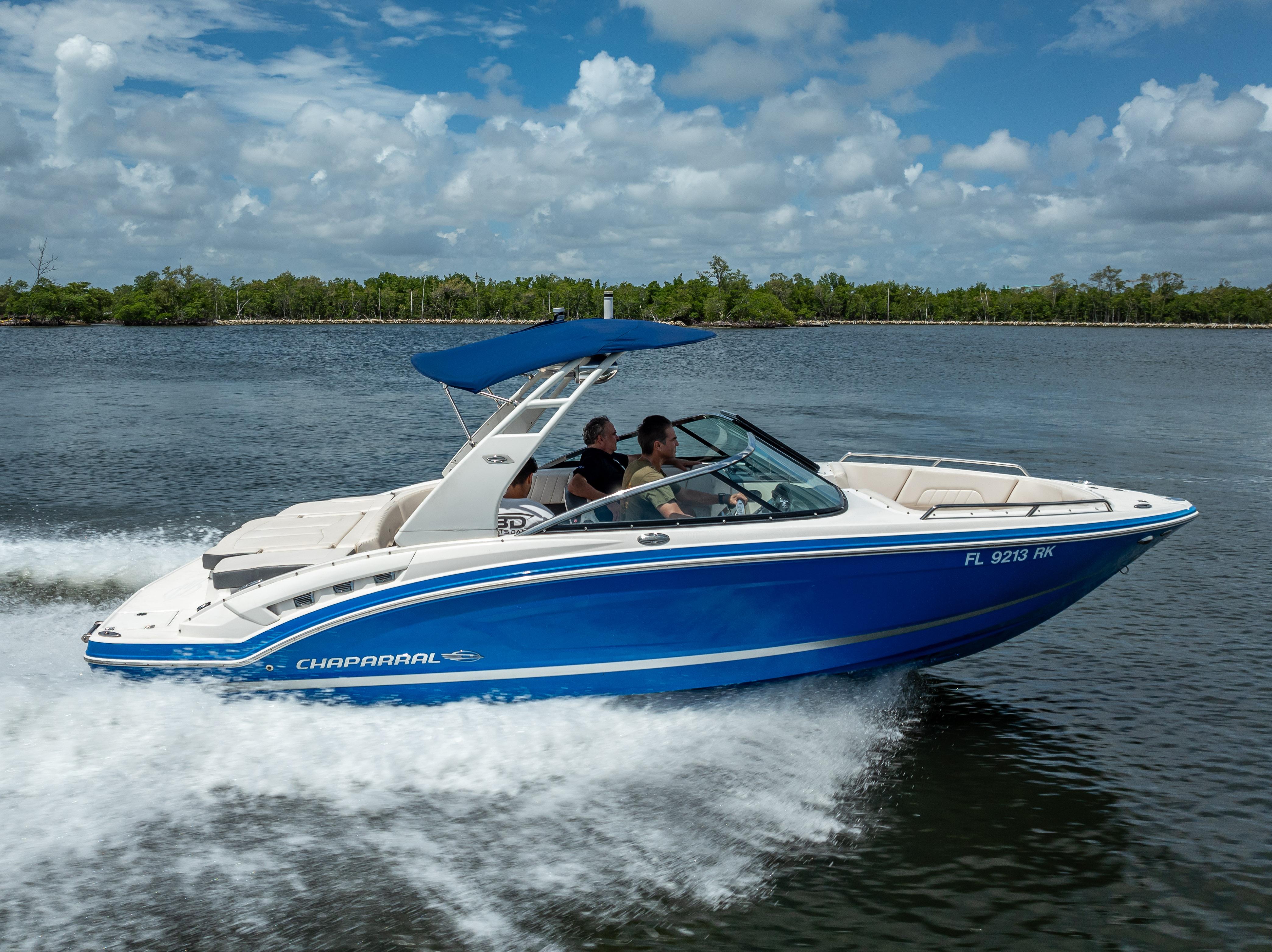 2017 Chaparral 227 SSX boat cruising on a sunny day with blue skies.