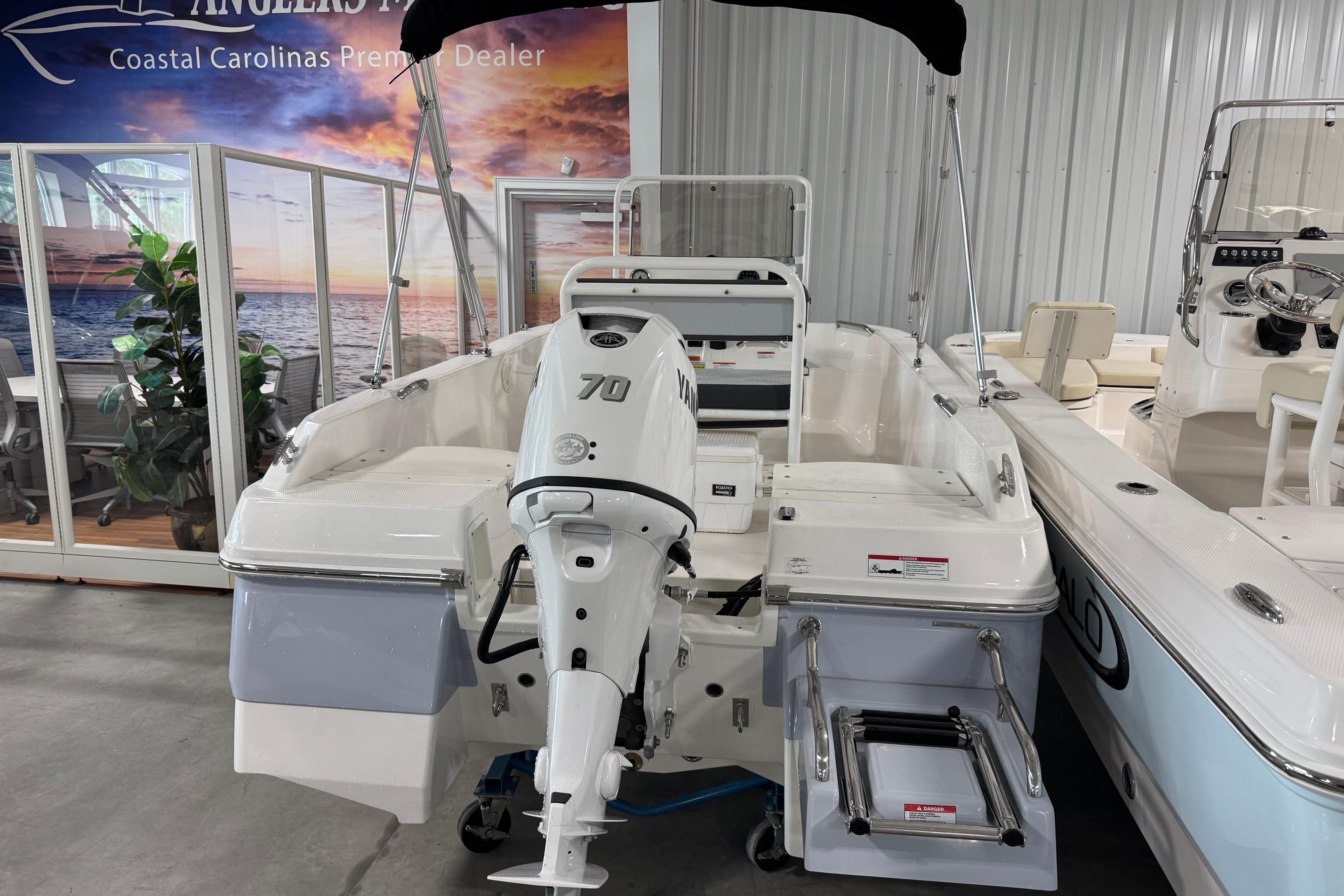 2026 Robalo R160 Center Console boat with Yamaha 70 engine in showroom.