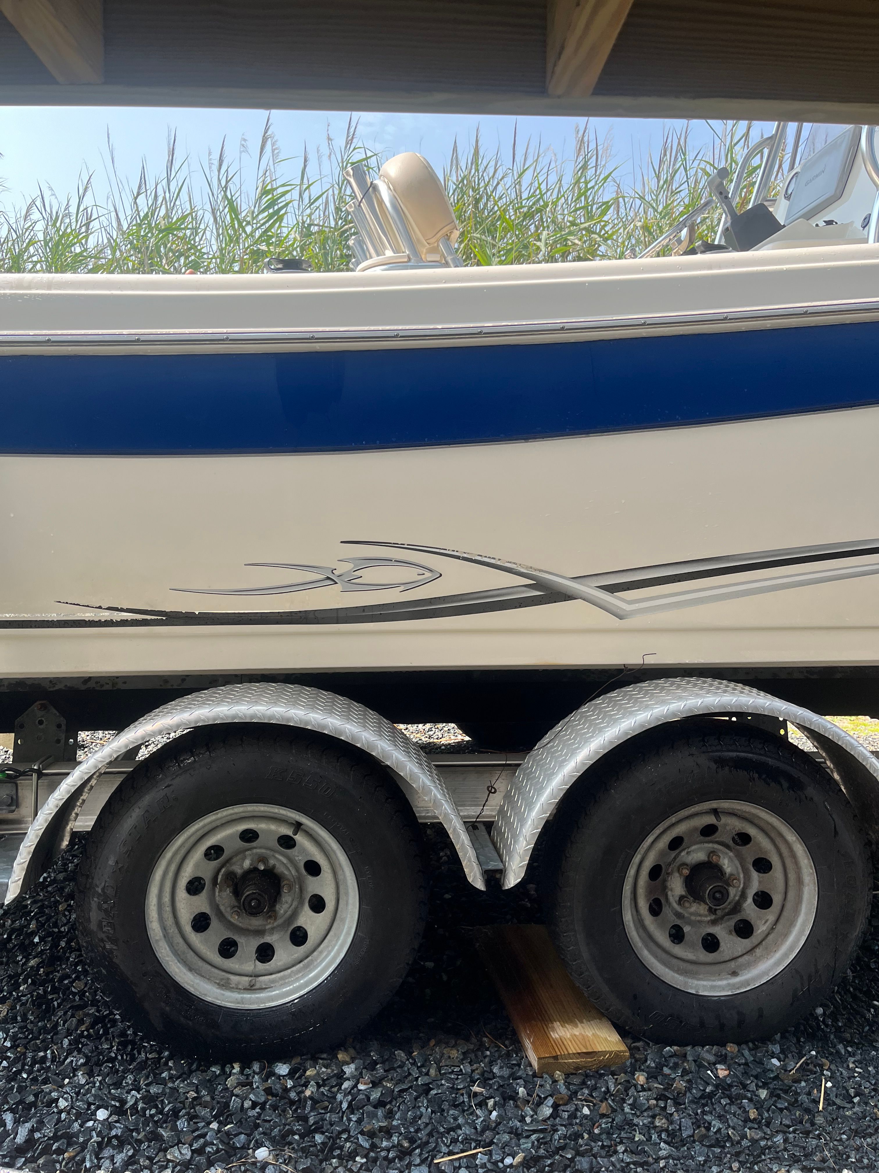 2014 Carolina Skiff 23 Ultra Elite on trailer, side view.
