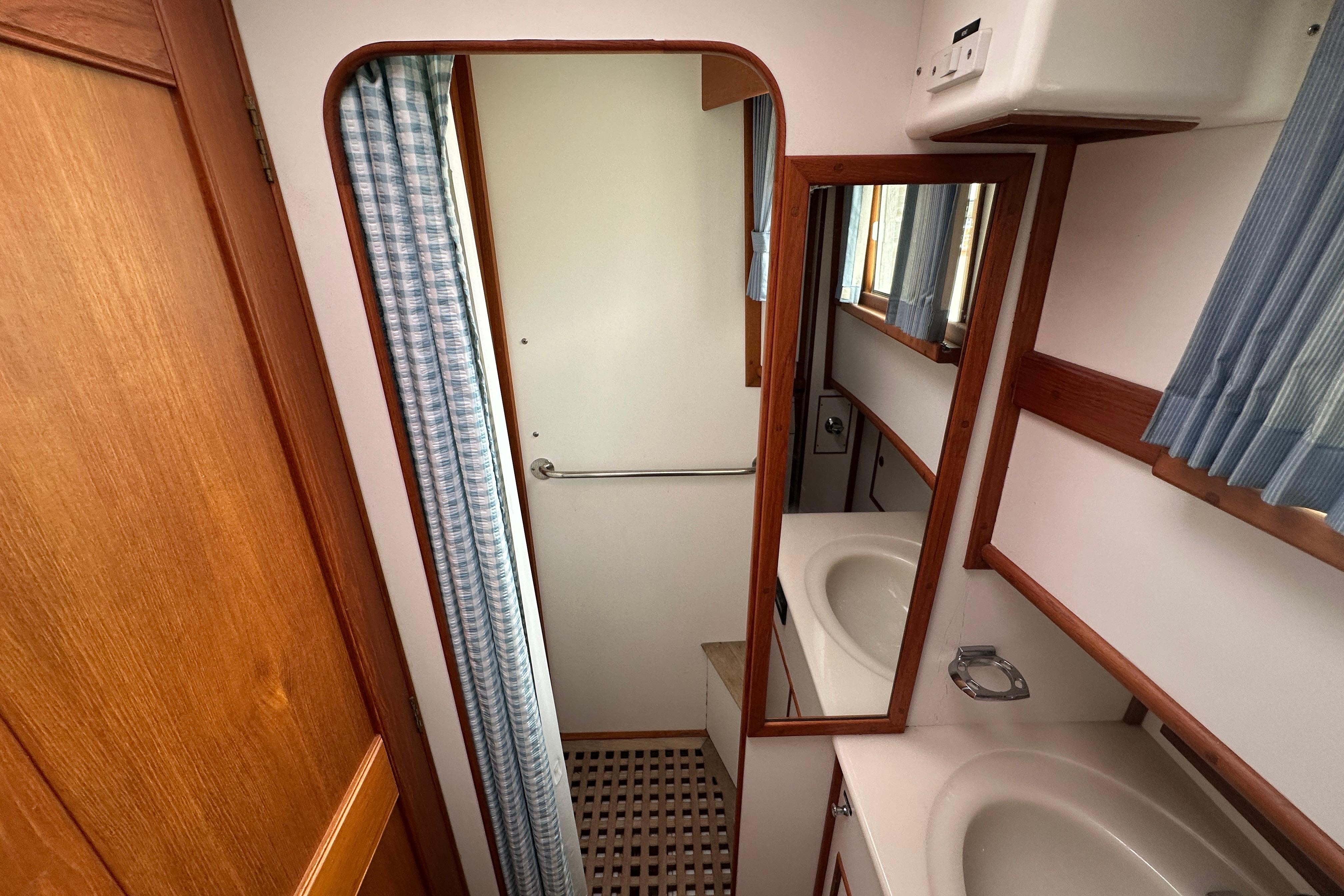 Bathroom interior of 1998 Grand Banks 49 Classic yacht with sink and mirror.