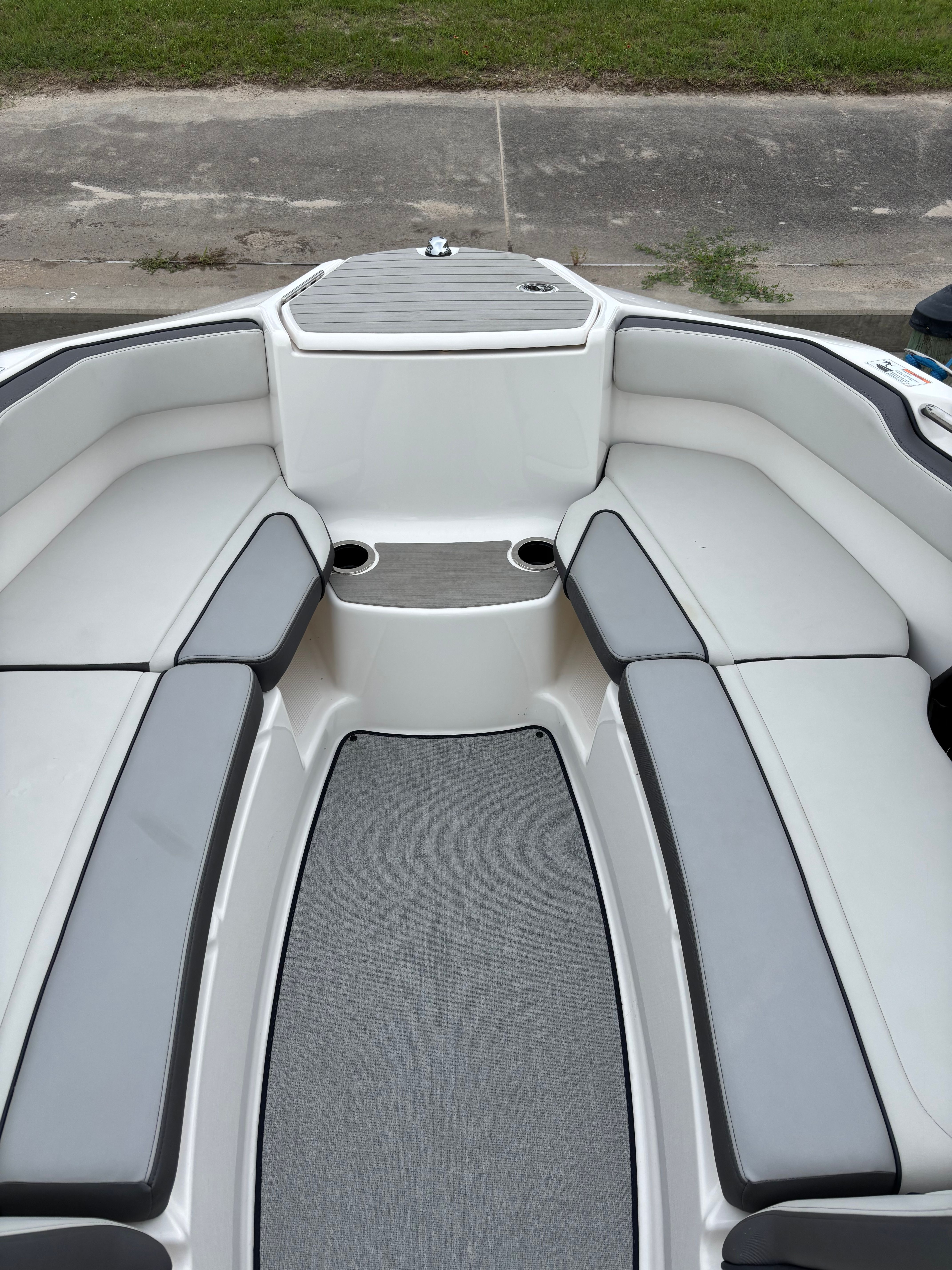 The image shows the interior of a Yamaha AR250 boat with gray and white seating.
