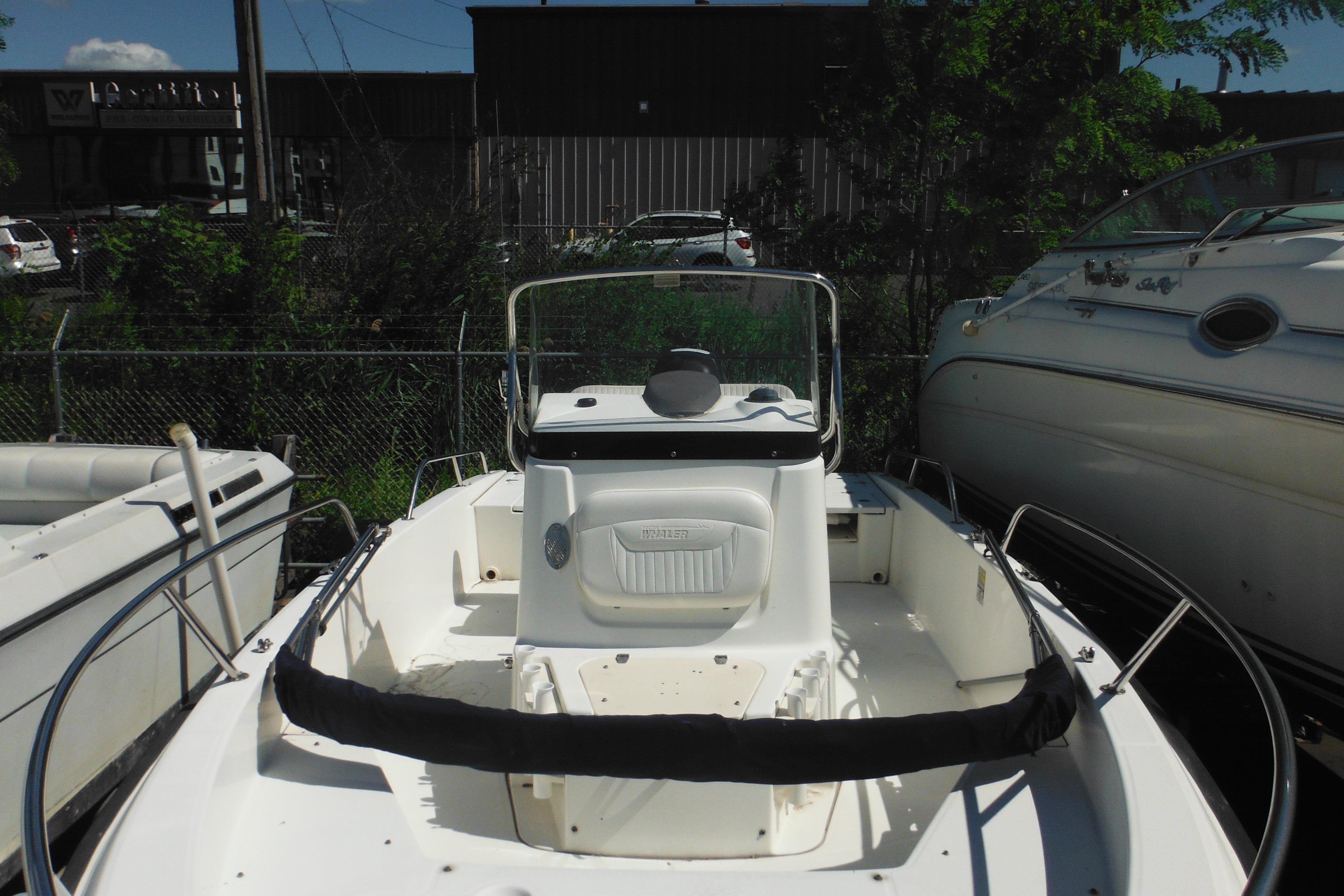 2009 Boston Whaler 200 Dauntless boat, white interior, parked outdoors.