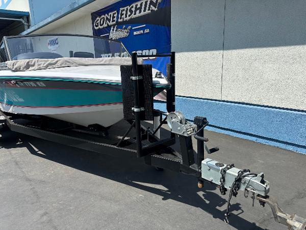 1992 Correct Craft Ski Nautique boat on trailer, parked outdoors.