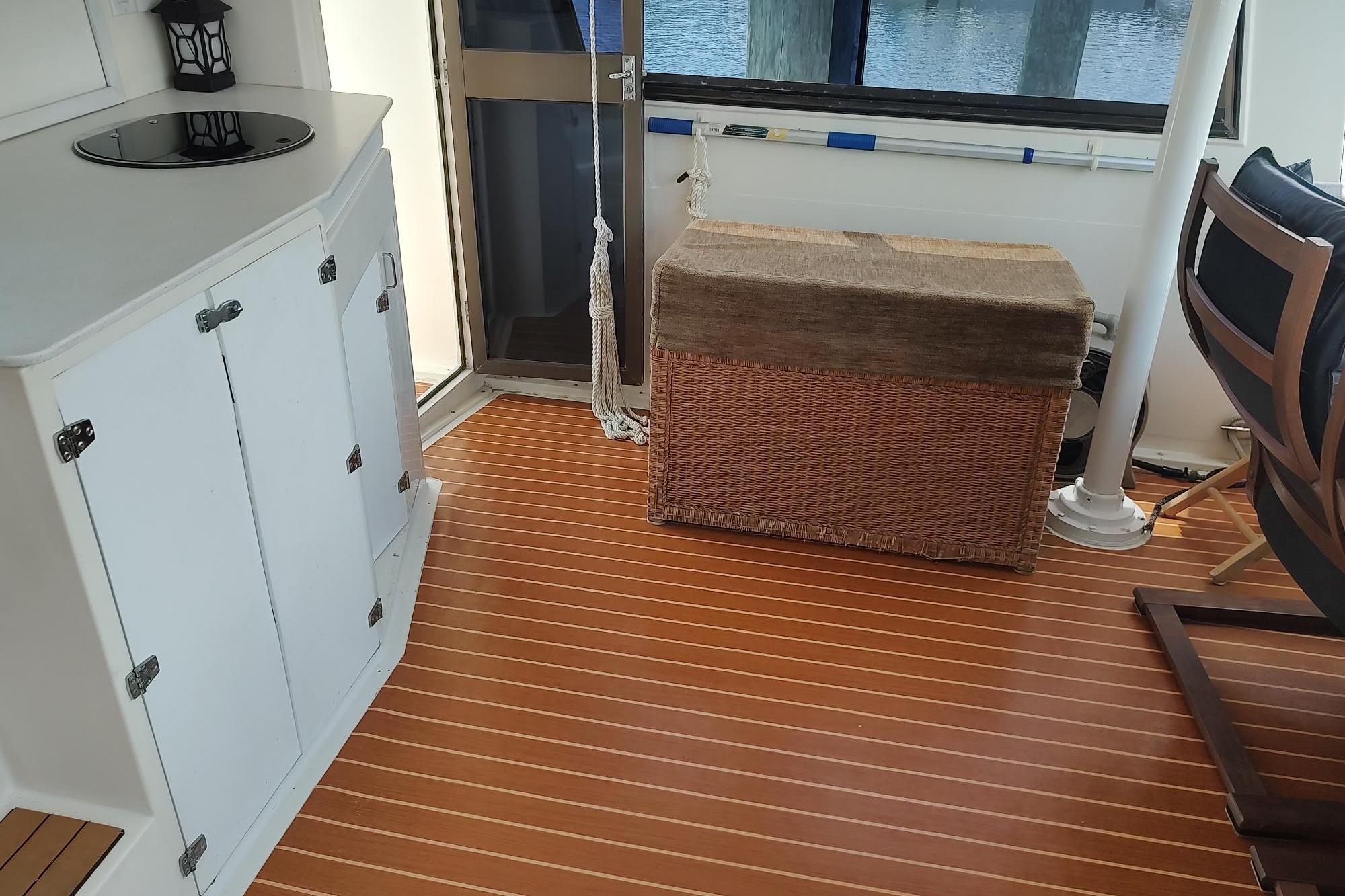 Interior of 1989 Hyatt Double Cabin Motoryacht with wooden flooring and wicker storage.