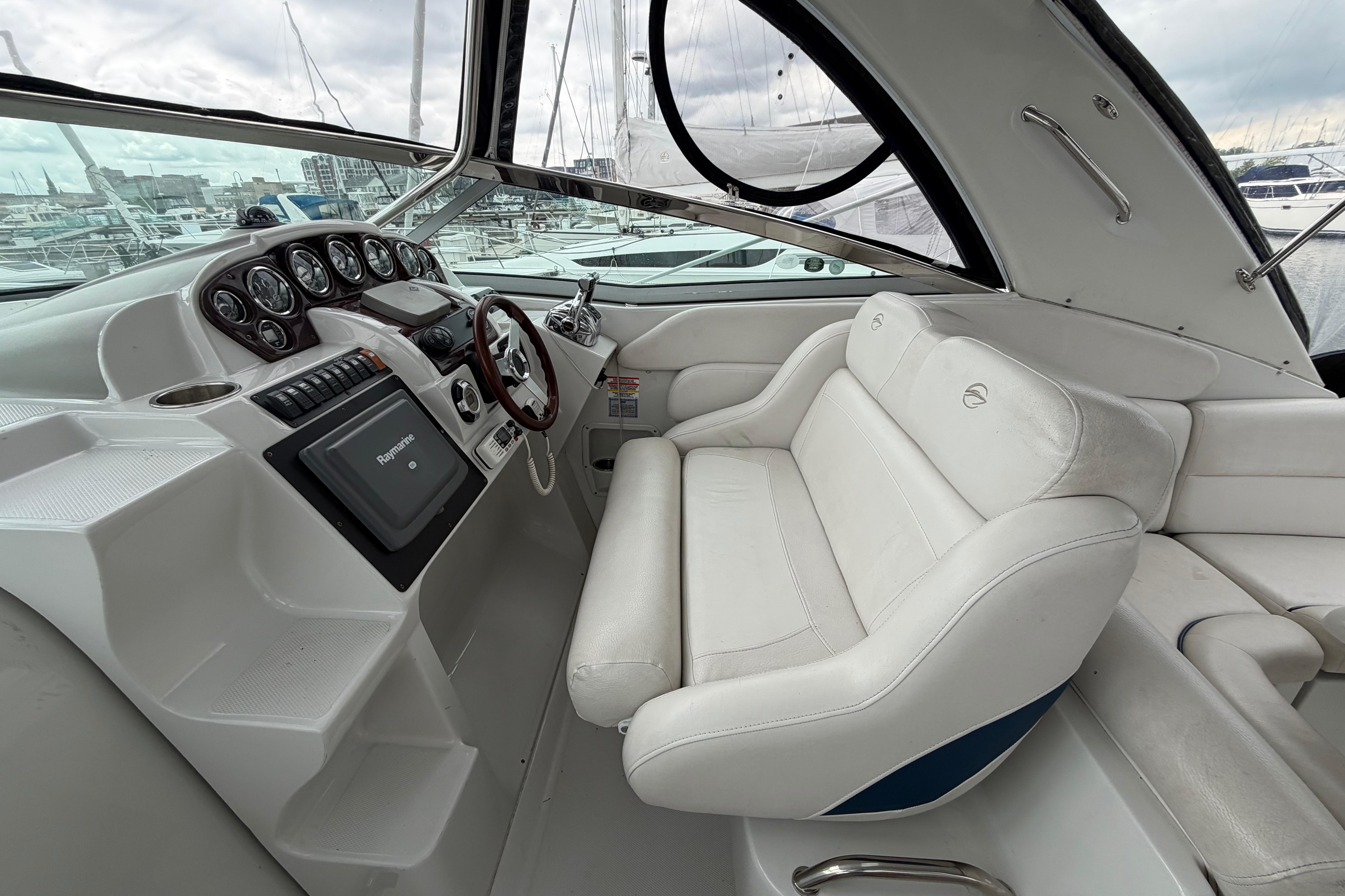 2008 Crownline 340 CR boat cockpit with white seating and modern dashboard controls.