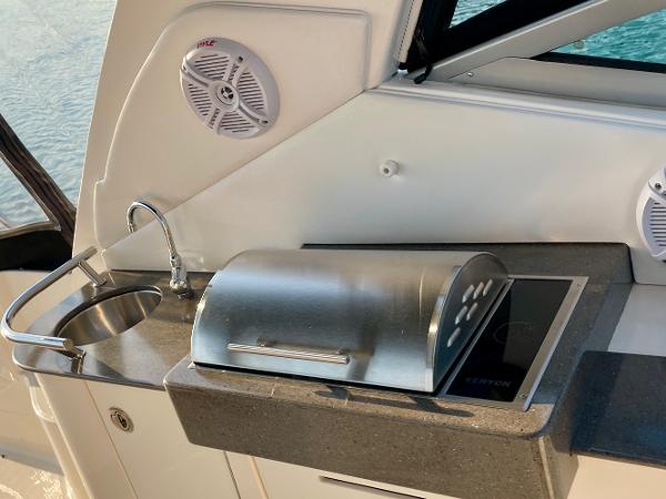 Outdoor kitchen on 2014 Sea Ray 330 Sundancer yacht with sink and grill.