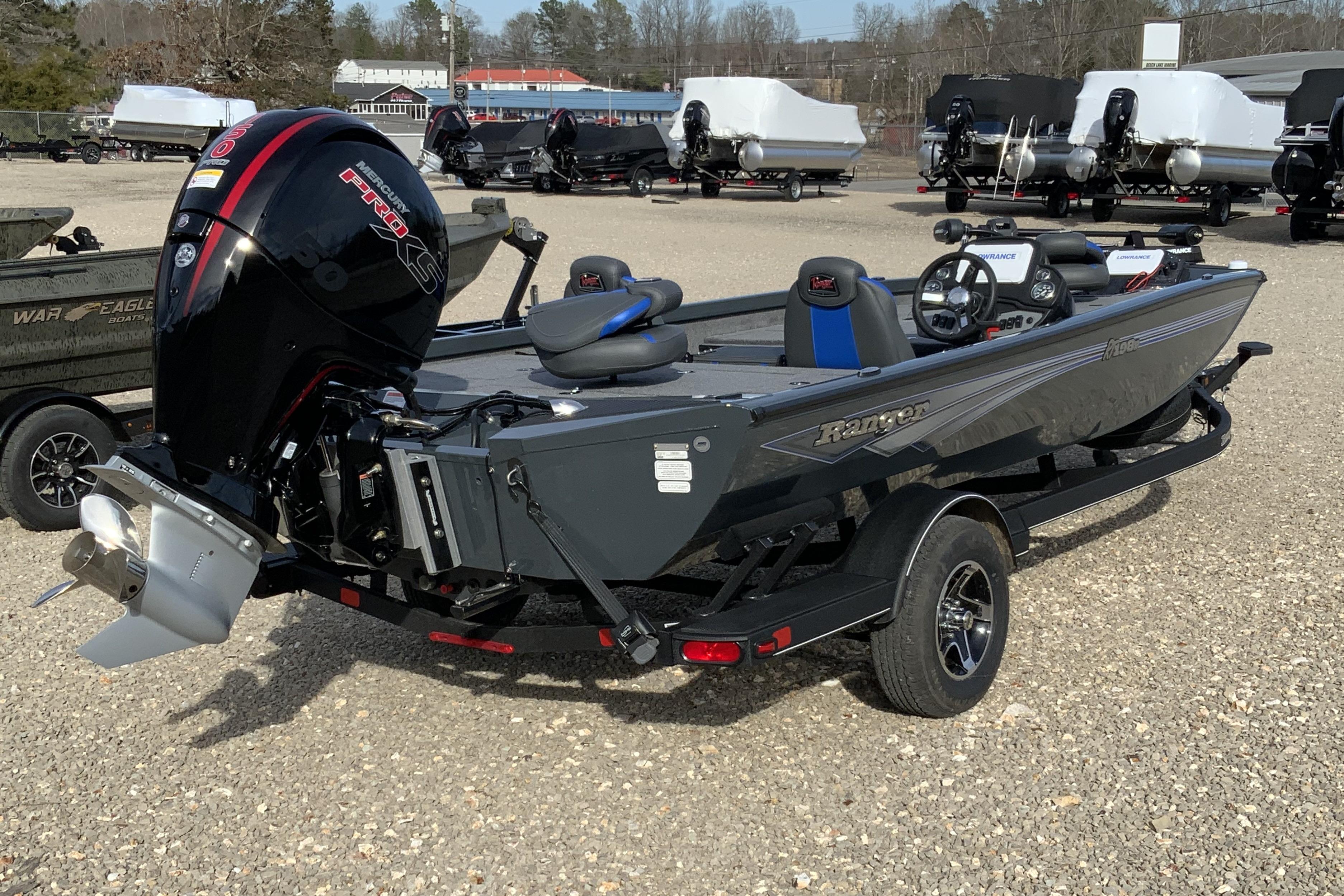 2026 Ranger RT198P fishing boat with Mercury Pro XS engine, parked on gravel.