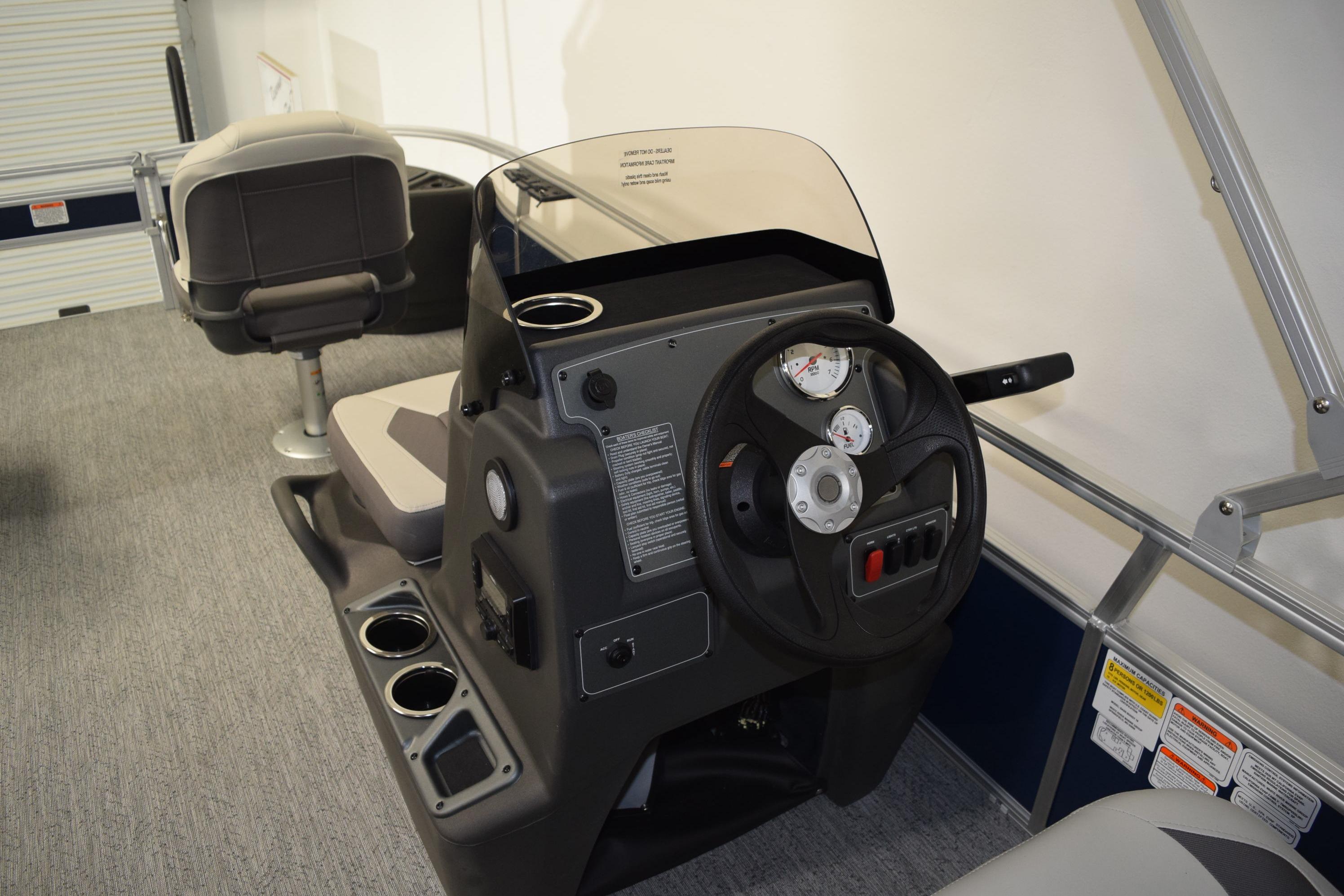 2026 Sun Tracker Bass Buggy 18 DLX pontoon boat interior with steering console and seating.