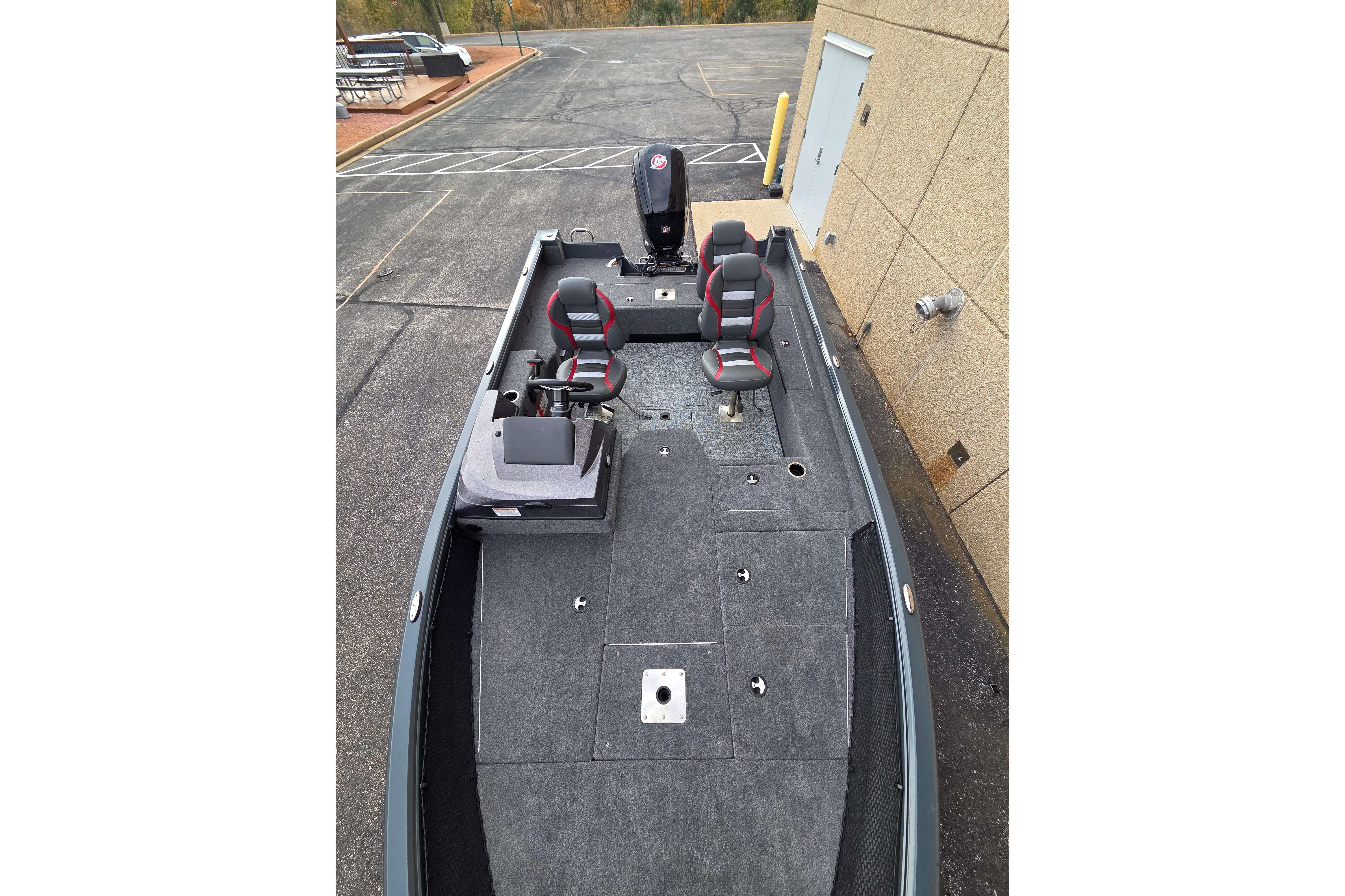 2025 Ranger VS1682SC Angler boat with dual seats and motor, parked on pavement.