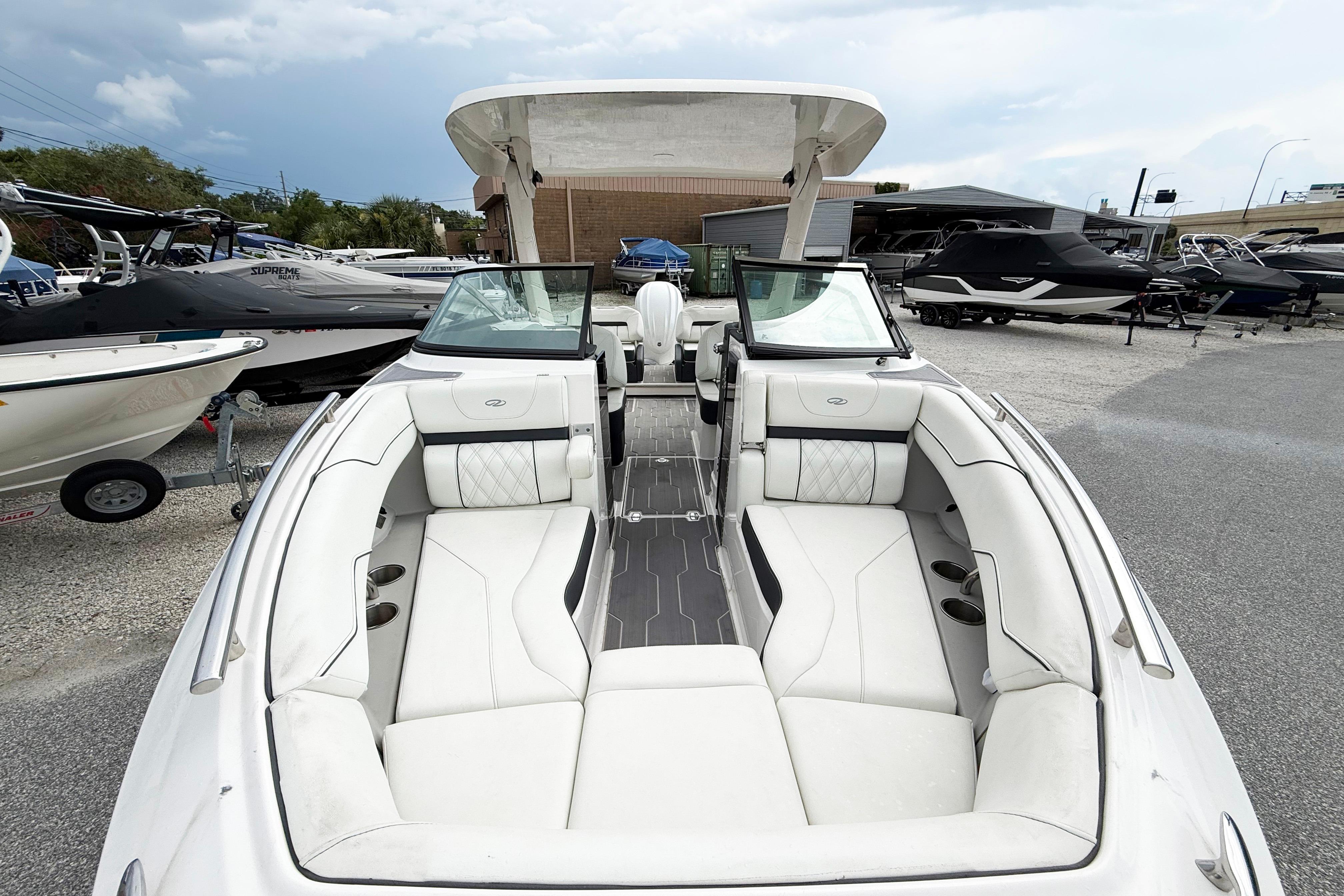 2024 Regal LX4 boat with luxurious white seating, displayed in a marina setting.