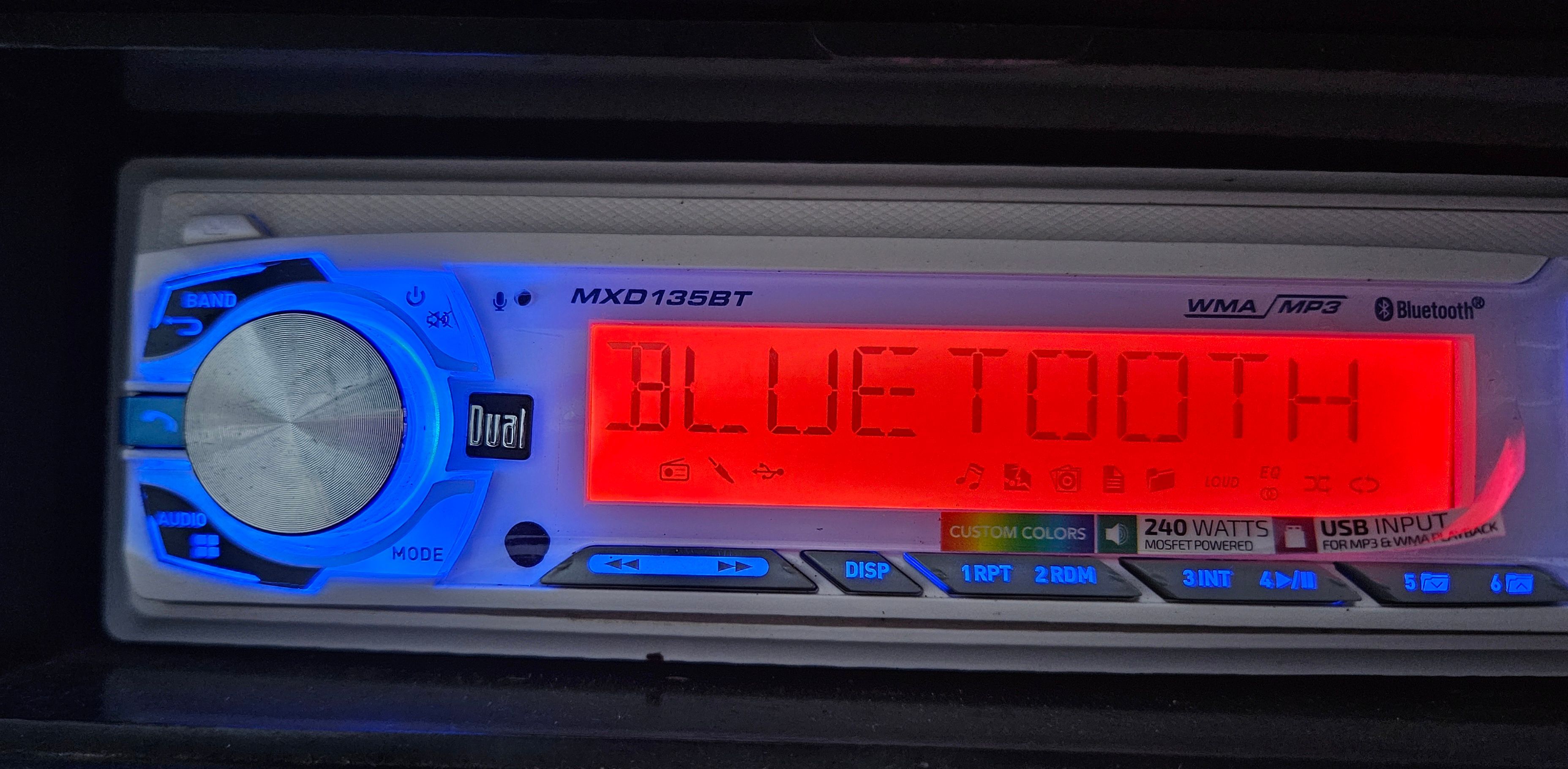 A blue-lit car stereo with Bluetooth capability.