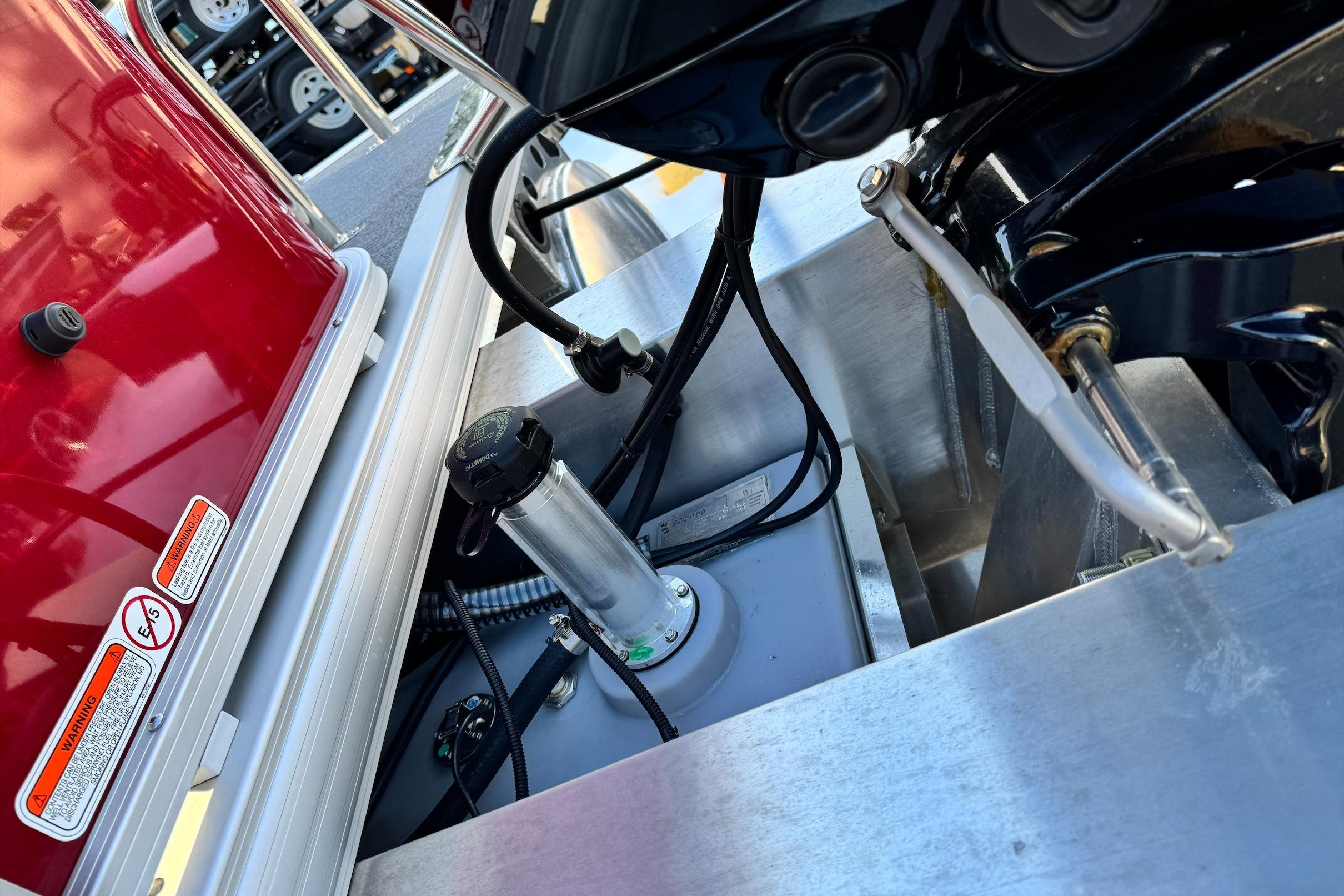 Close-up of 2026 Sun Tracker Bass Buggy 18 DLX boat engine compartment.